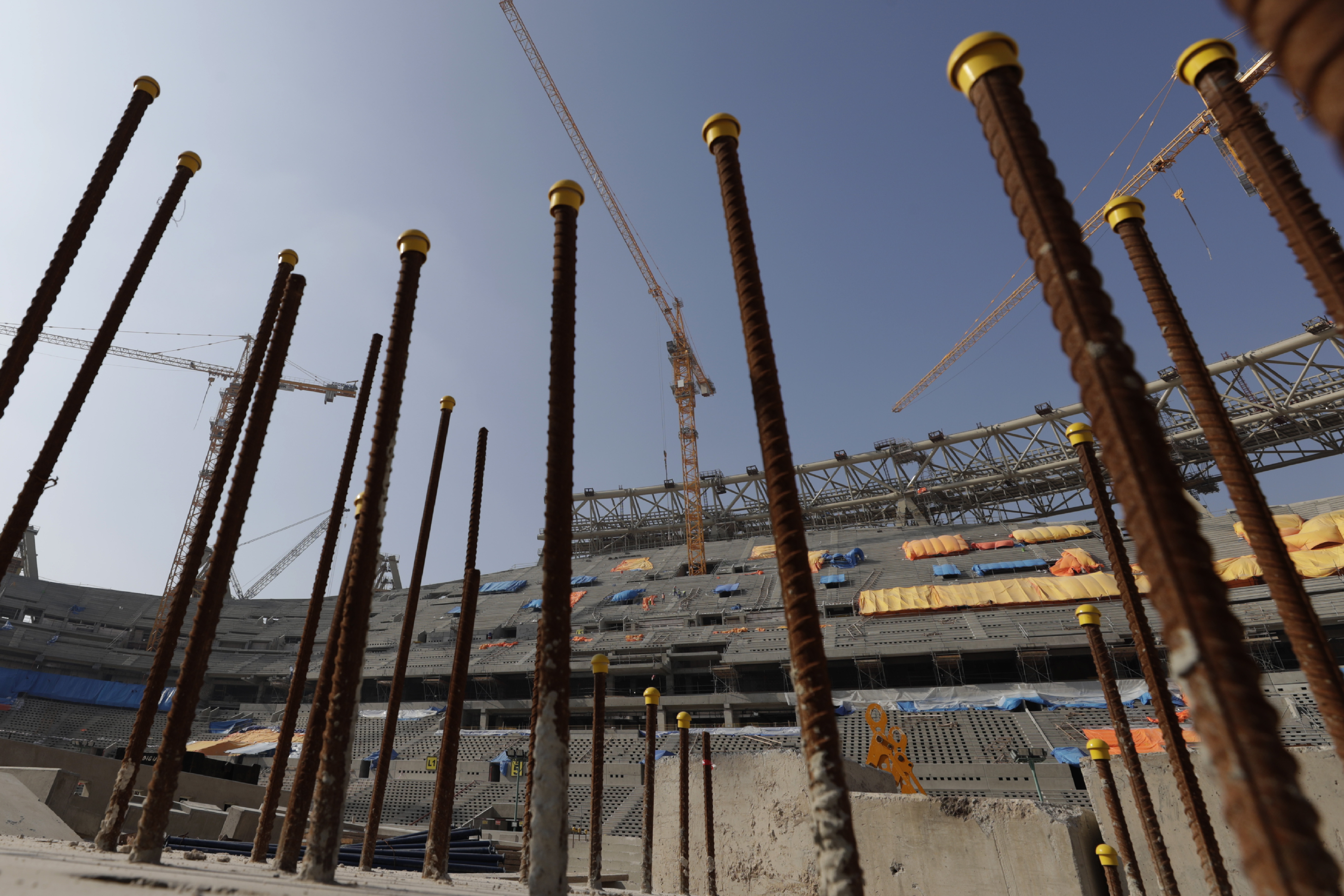 Workers work at Lusail Stadium, one of the 2022 World Cup stadiums, in Lusail, Qatar, Friday, Dec. 20, 2019. Construction is underway to complete Lusail's 80,000-seat venue for the opening game and final in a city that didn't exist when Qatar won the FIFA vote in 2010. (AP Photo/Hassan Ammar)