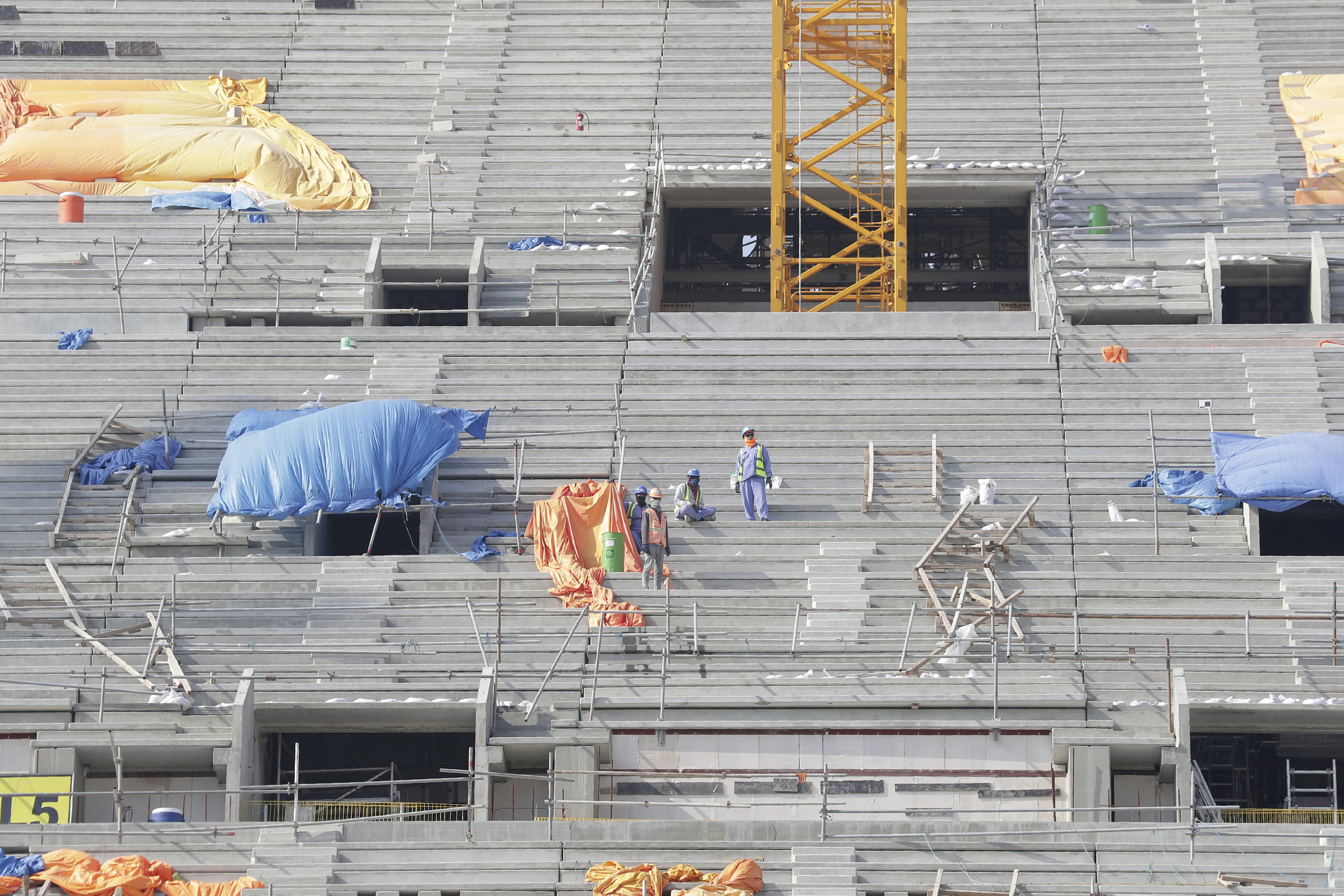 Workers work at Lusail Stadium, one of the 2022 World Cup stadiums, in Lusail, Qatar, Friday, Dec. 20, 2019. Construction is underway to complete Lusail's 80,000-seat venue for the opening game and final in a city that didn't exist when Qatar won the FIFA vote in 2010. (AP Photo/Hassan Ammar)