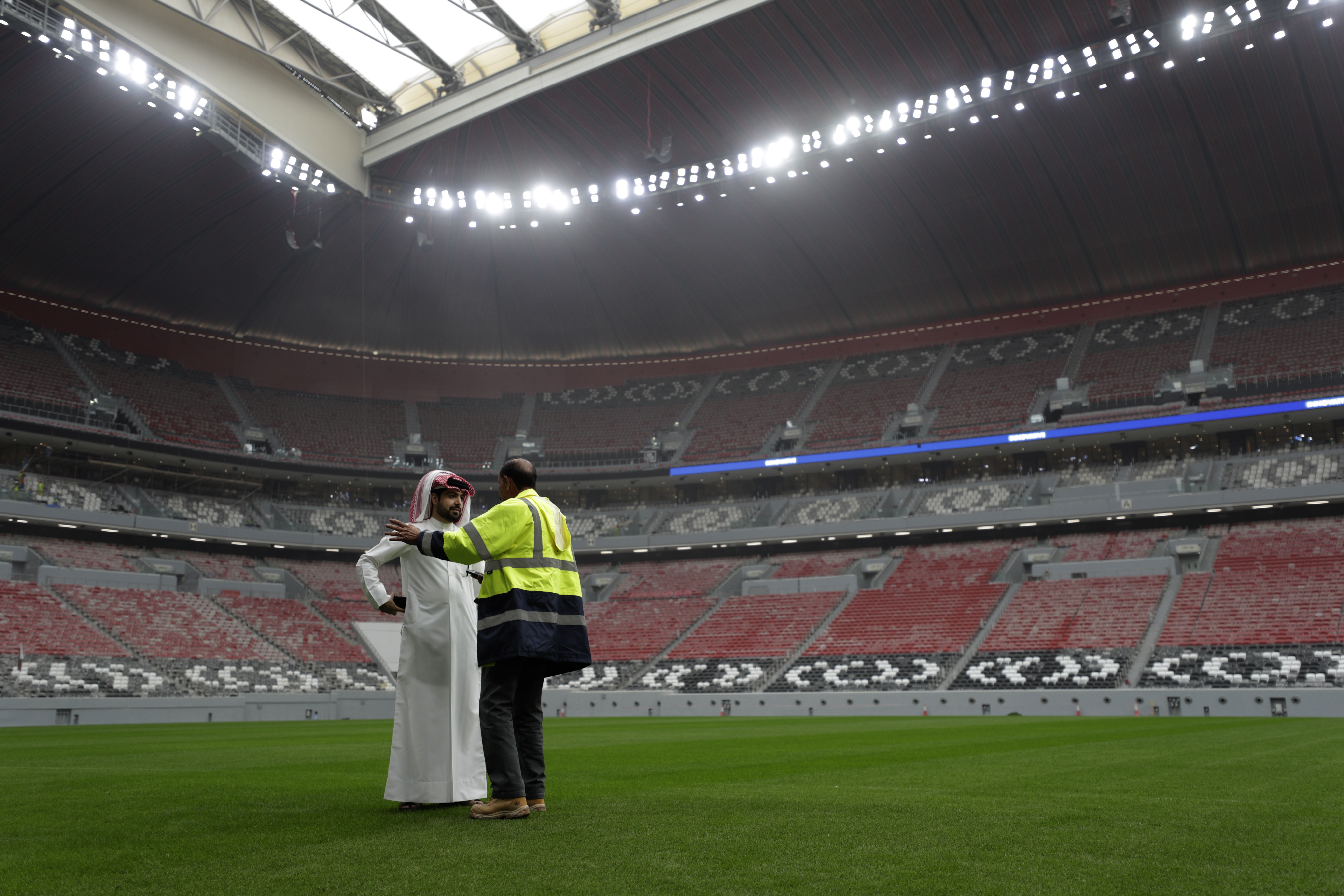 Workers work at the Al Bayt Stadium, one of the 2022 World Cup stadiums, in Al Khor, about 50 kilometers (30 miles) north of Doha, Qatar, Tuesday, Dec. 17, 2019. The Al Bayt 60,000 seats stadium with Qatari tent shaped facade has a retractable roof. (AP Photo/Hassan Ammar)