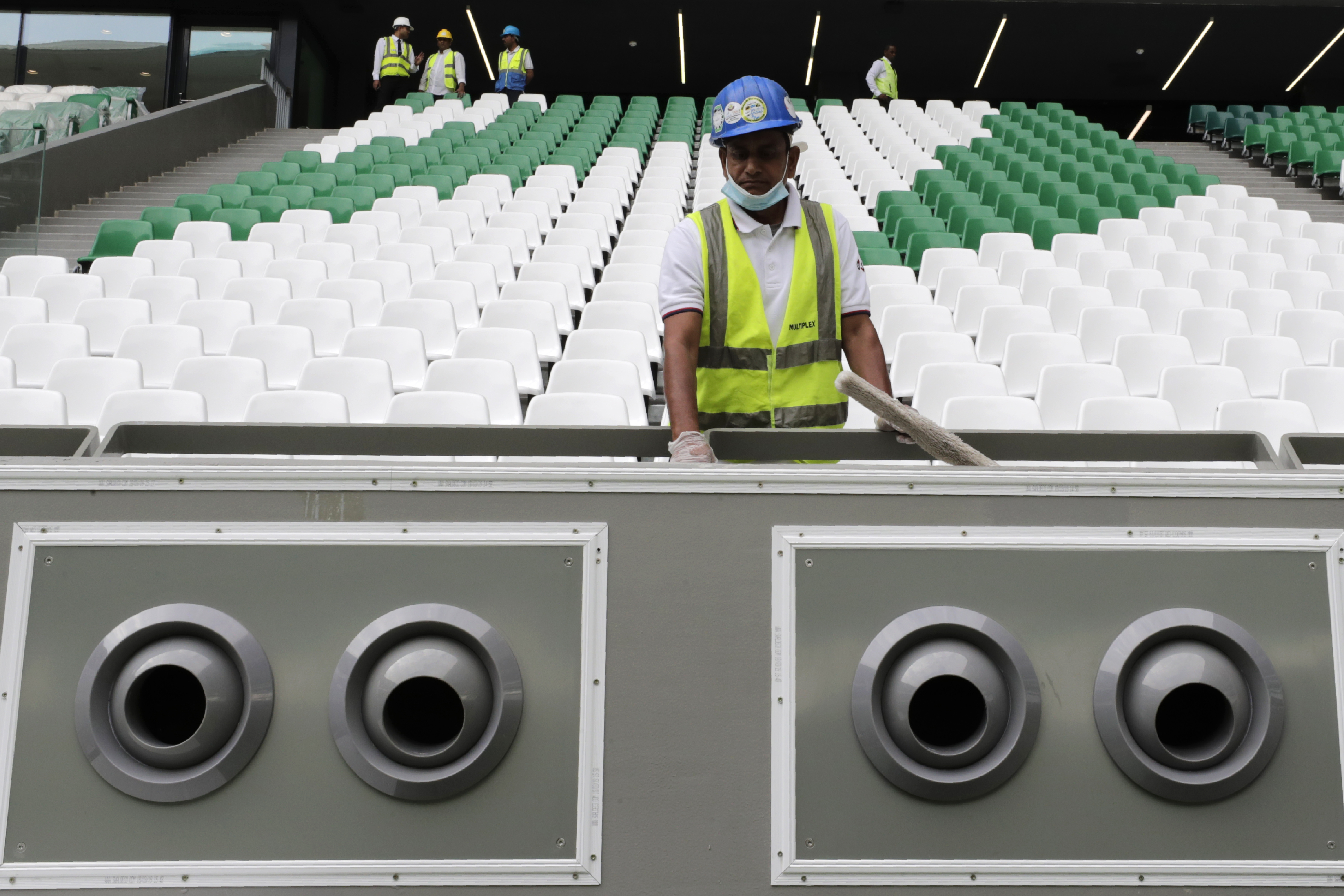 A worker cleans over a giant air conditioning at the Qatar Education Stadium, one of the 2022 World Cup stadiums, an open cooled stadium with a 45,350-seat capacity in Doha, Qatar, Sunday, Dec. 15, 2019. Qatar Education Stadium it isan open cooled stadium with a 45,350-seat capacity and is located in the middle of several university campuses at the Qatar Foundation's Education City in Doha. (AP Photo/Hassan Ammar)