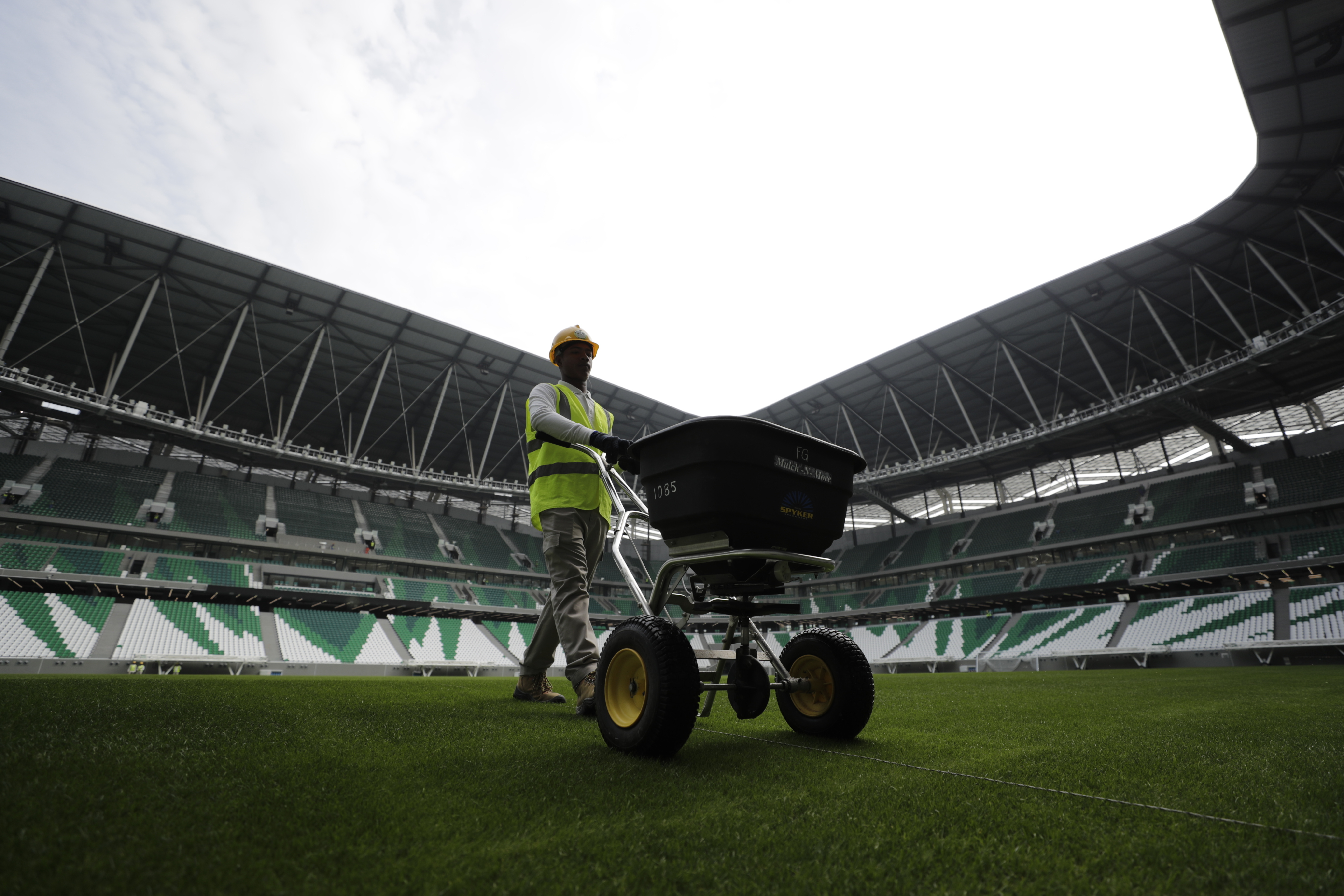 A worker maintain the pitch of the Qatar Education Stadium, one of the 2022 World Cup stadiums, an open cooled stadium with a 45,350-seat capacity in Doha, Qatar, Sunday, Dec. 15, 2019. Qatar Education Stadium it isan open cooled stadium with a 45,350-seat capacity and is located in the middle of several university campuses at the Qatar Foundation's Education City in Doha. (AP Photo/Hassan Ammar)