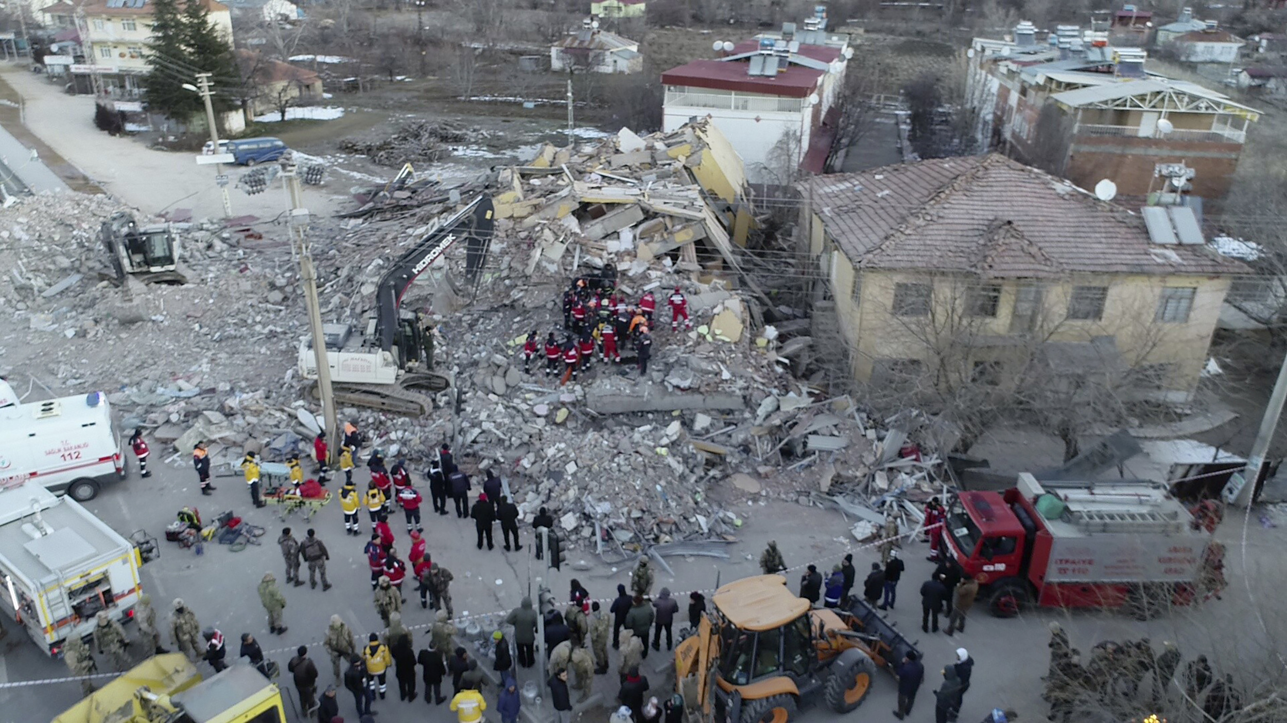 Rescuers work on a collapsed building after a strong earthquake struck in Elazig in the eastern Turkey, Saturday, Jan. 25, 2020. The earthquake rocked eastern Turkey on Friday, causing some buildings to collapse and killing scores of people, Turkish officials said. (IHA via AP)