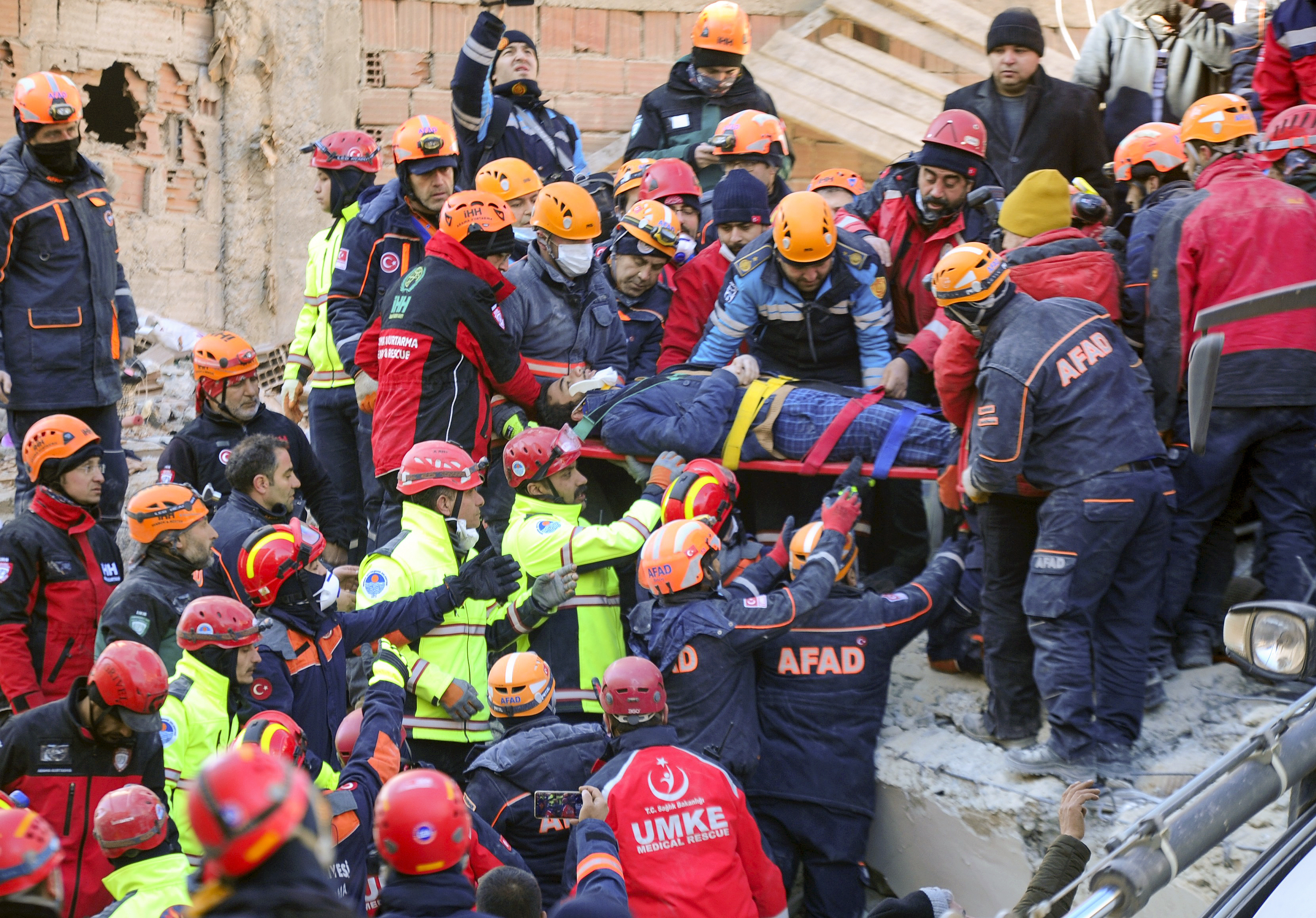 Rescuers work on a collapsed building after a strong earthquake struck in Elazig in the eastern Turkey, Saturday, Jan. 25, 2020. The earthquake rocked eastern Turkey on Friday, causing some buildings to collapse and killing scores of people, Turkish officials said. (IHA via AP)