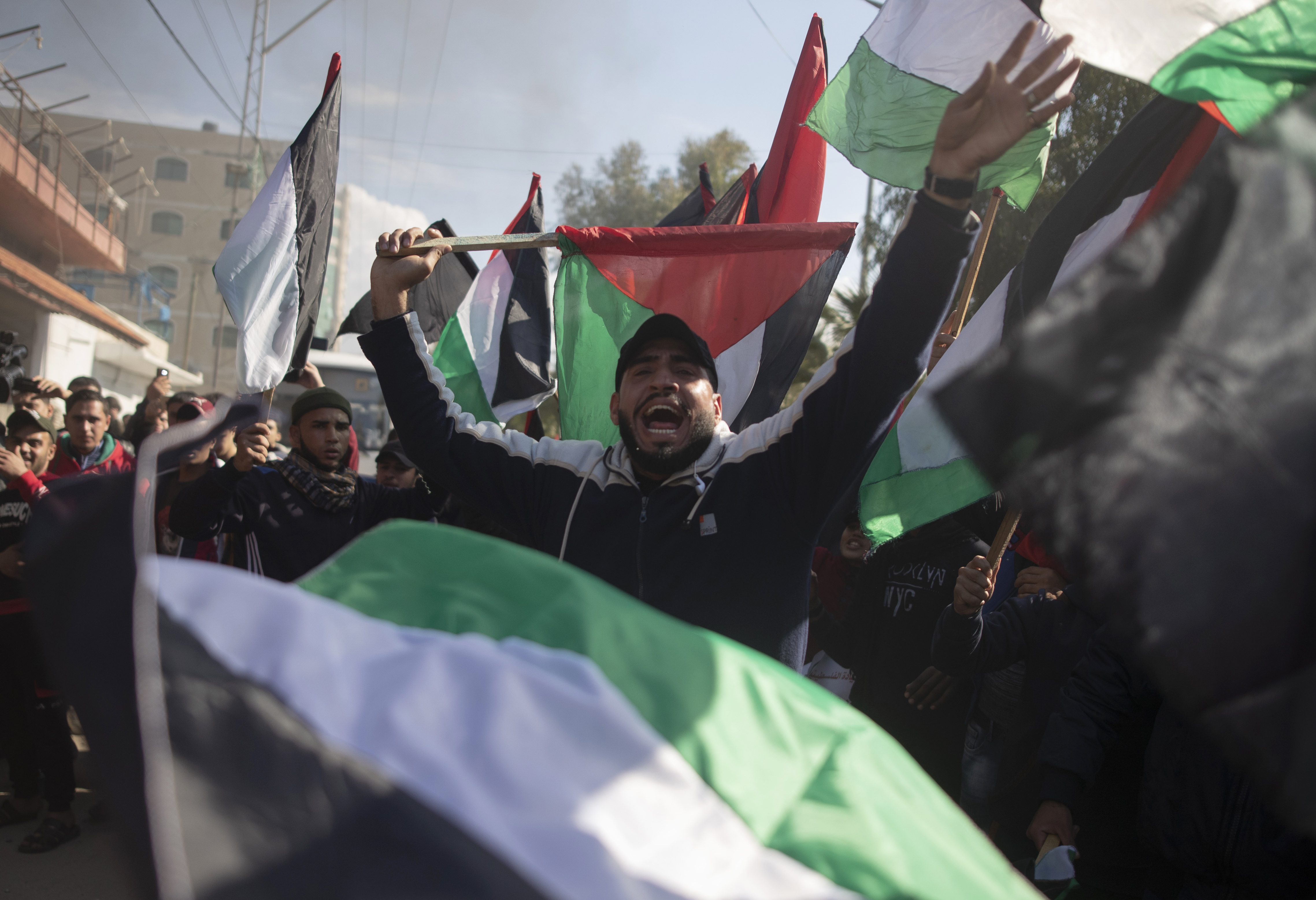 Palestinian protesters wave national flags and chant angry slogans during a protest against the U.S. Mideast peace plan, in Gaza City, Monday, Jan. 28, 2020. U.S. President Donald Trump is set to unveil his administration's much-anticipated Mideast peace plan in the latest U.S.  venture to resolve the Israeli-Palestinian conflict. (AP Photo/Khalil Hamra)