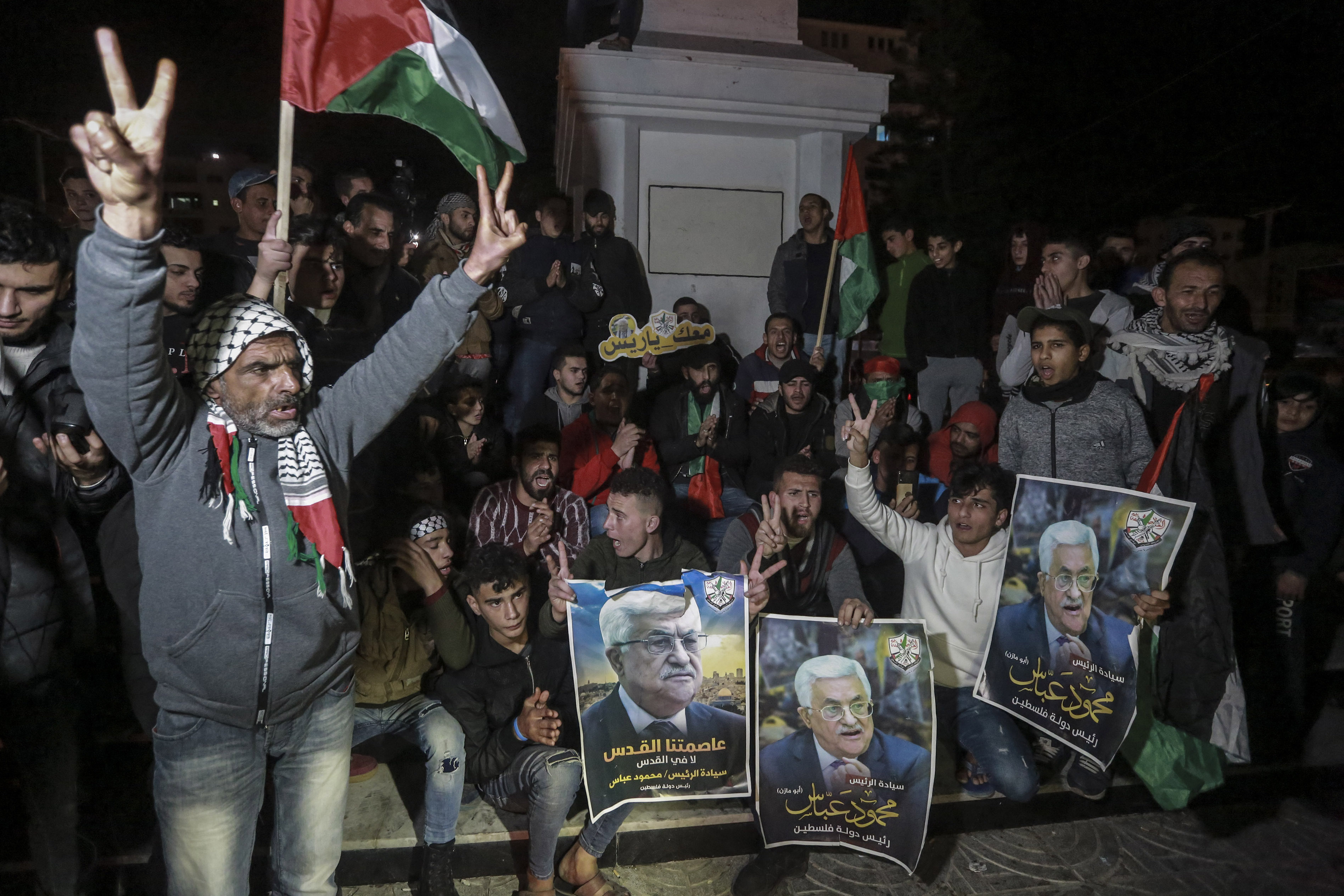 28 January 2020, Palestinian Territories, Gaza City: Palestinian demonstrators hold pictures of Palestinian President Mahmoud Abbas during a demonstration against US President Donald Trump's Middle East peace plan. Photo by: Mohammed Talatene/picture-alliance/dpa/AP Images