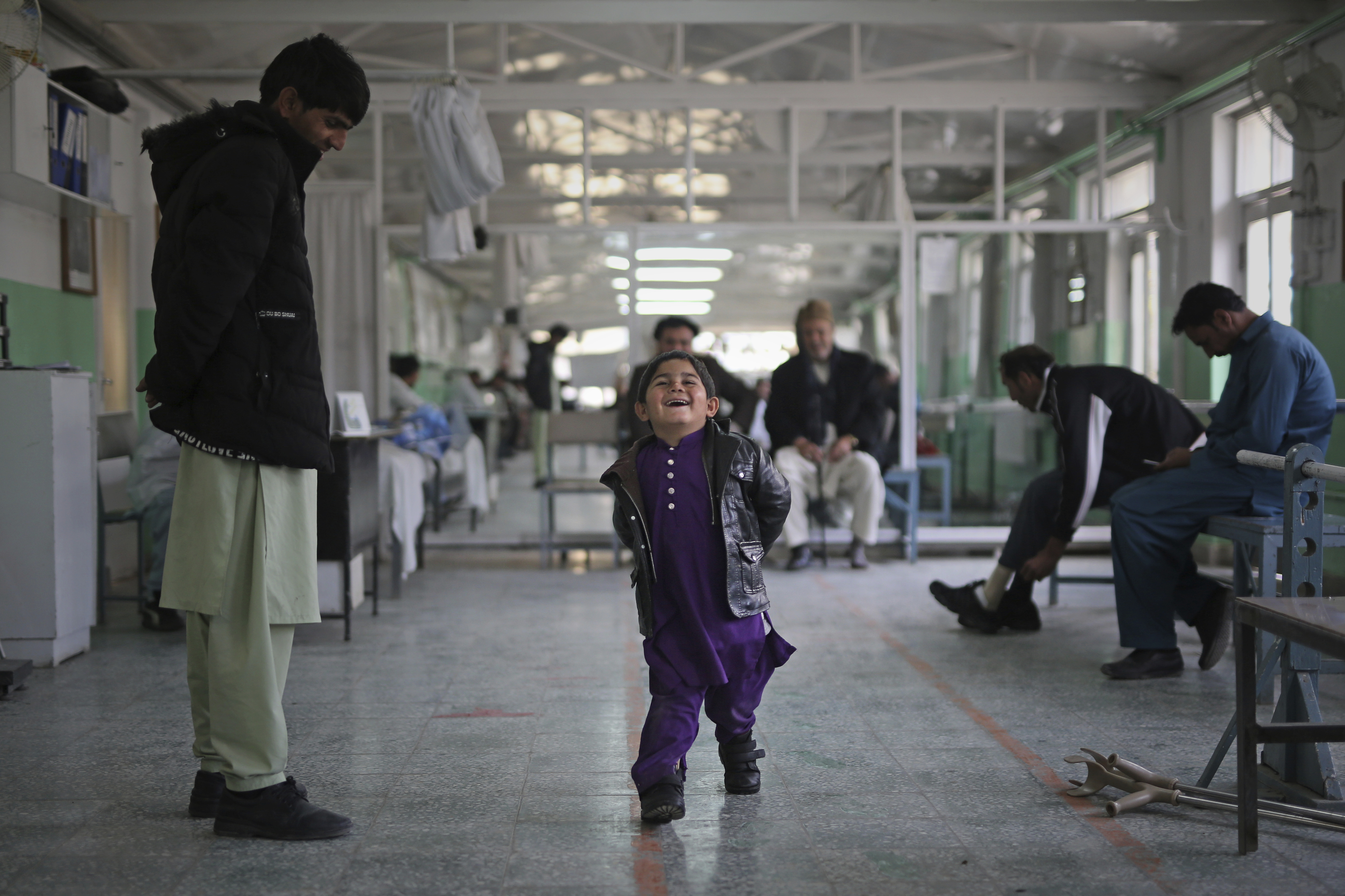 Six year-old Inamullah, who is suffering from clubfoot, grins as he walks without any assistance for the first time in his life at the International Committee of the Red Cross (ICRC) physical rehabilitation center in Kabul, Afghanistan, Sunday, Dec. 1, 2019. Since the ICRC began its rehabilitation program in Afghanistan in 1988, over 177,000 people, including over 46,000 amputees, have been treated at its centers across the country. Among the amputees registered, 77% were landmine victims and 70% civilians. (AP Photo/Altaf Qadri)