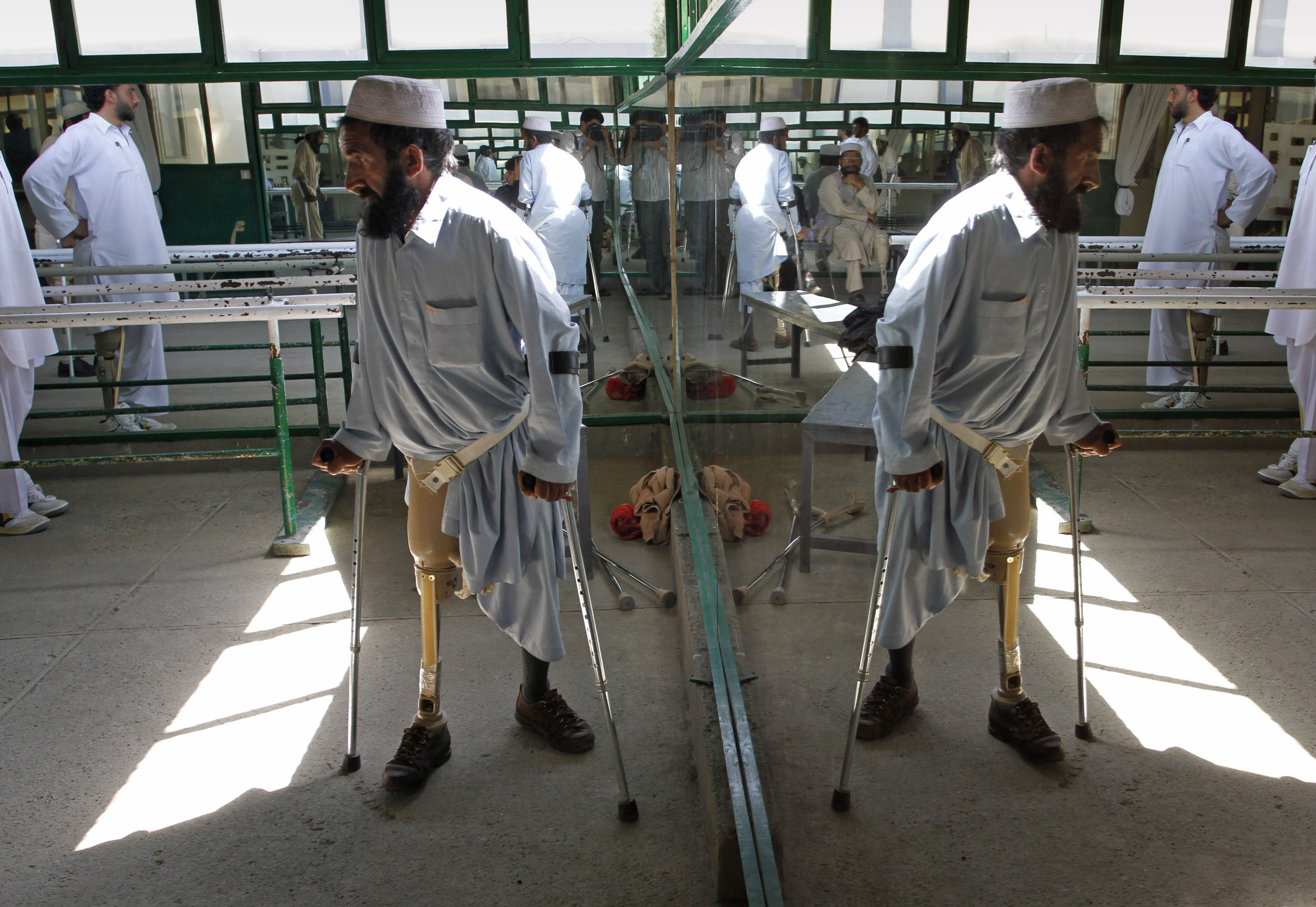 An Afghan victim of landmine walks with his new artificial leg at The International Committee of the Red Cross (ICRC) Orthopaedic Center in Kabul, Afghanistan, on Wednesday, March 31, 2010, ahead of International Mine Action Day that falls on April 4. (AP Photo/Musadeq Sadeq)