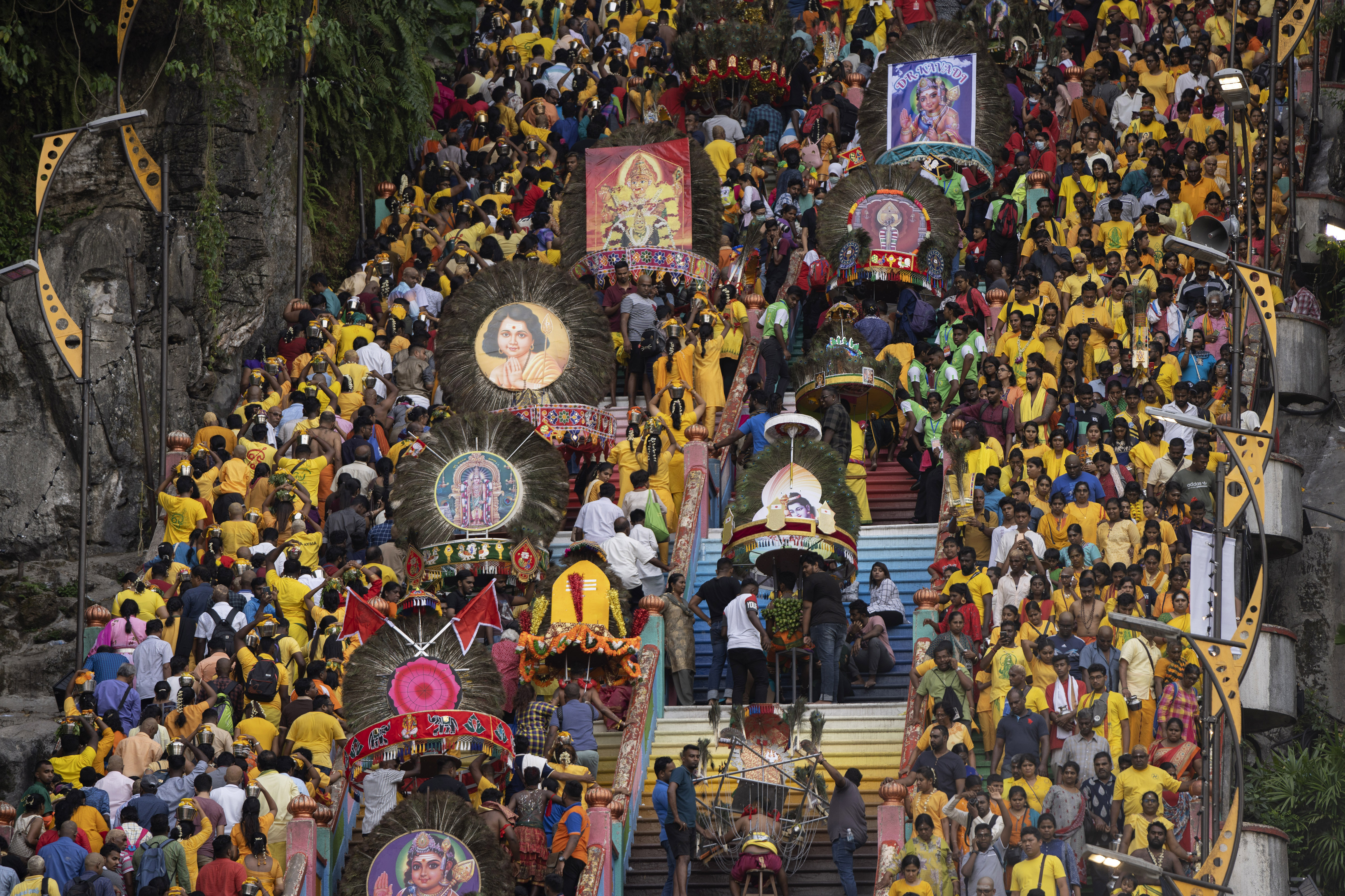 Giant Kavadi offering cages are carried by Hindu devotees in a procession during the Thaipusam festival at Batu Caves, outskirts of Kuala Lumpur, Saturday, Feb. 8, 2020. Thaipusam, which is celebrated in honor of Hindu god Lord Murugan, is an annual procession by Hindu devotees seeking blessings, fulfilling vows and offering thanks. (AP Photo/Vincent Thian)