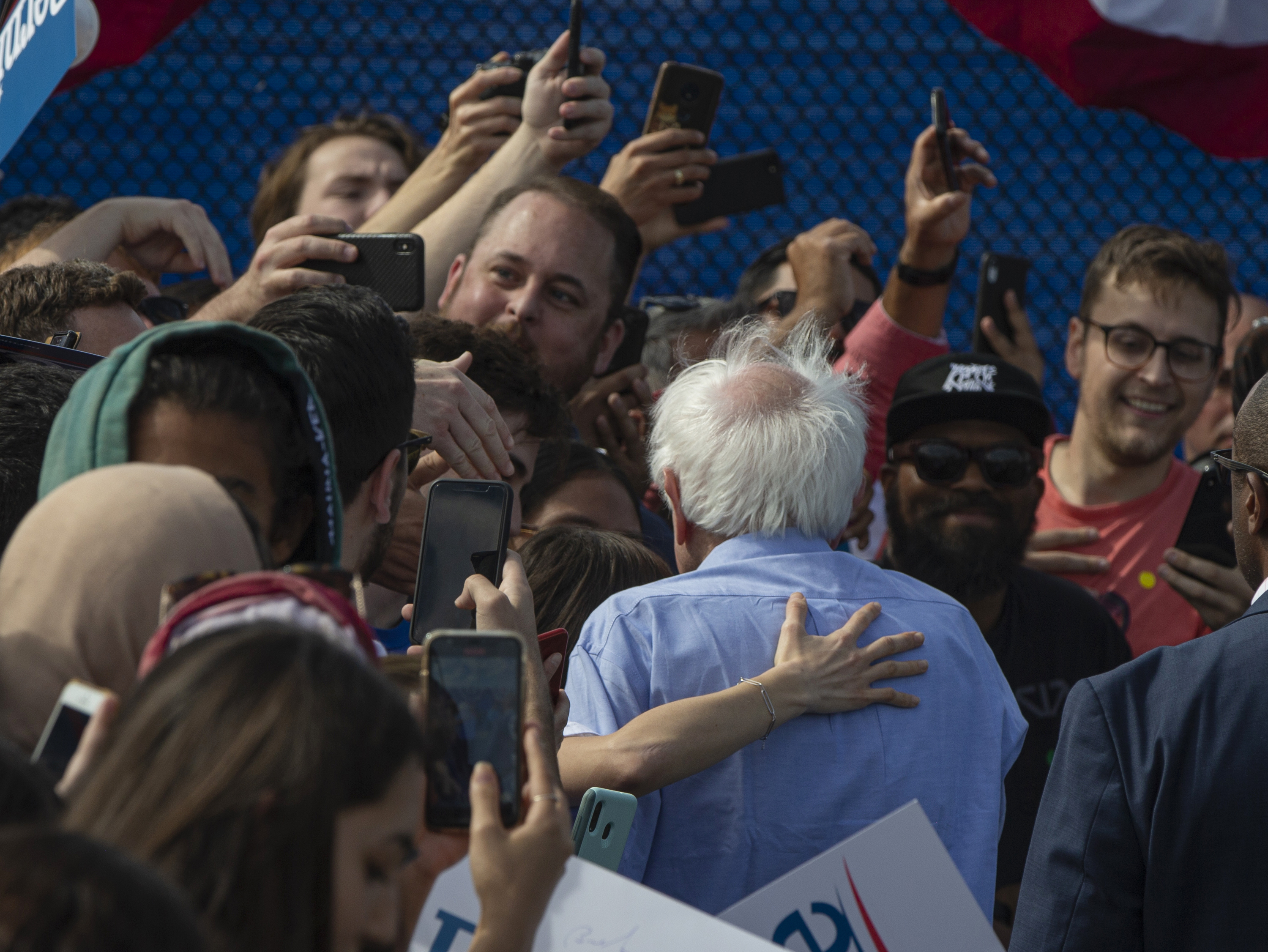 A supporter hugs Democratic presidential candidate Sen. Bernie Sanders, I-Vt., as he signs autographs at a campaign event at Valley High School in Santa Ana, Calif., Friday, Feb. 21, 2020. (AP Photo/Damian Dovarganes)