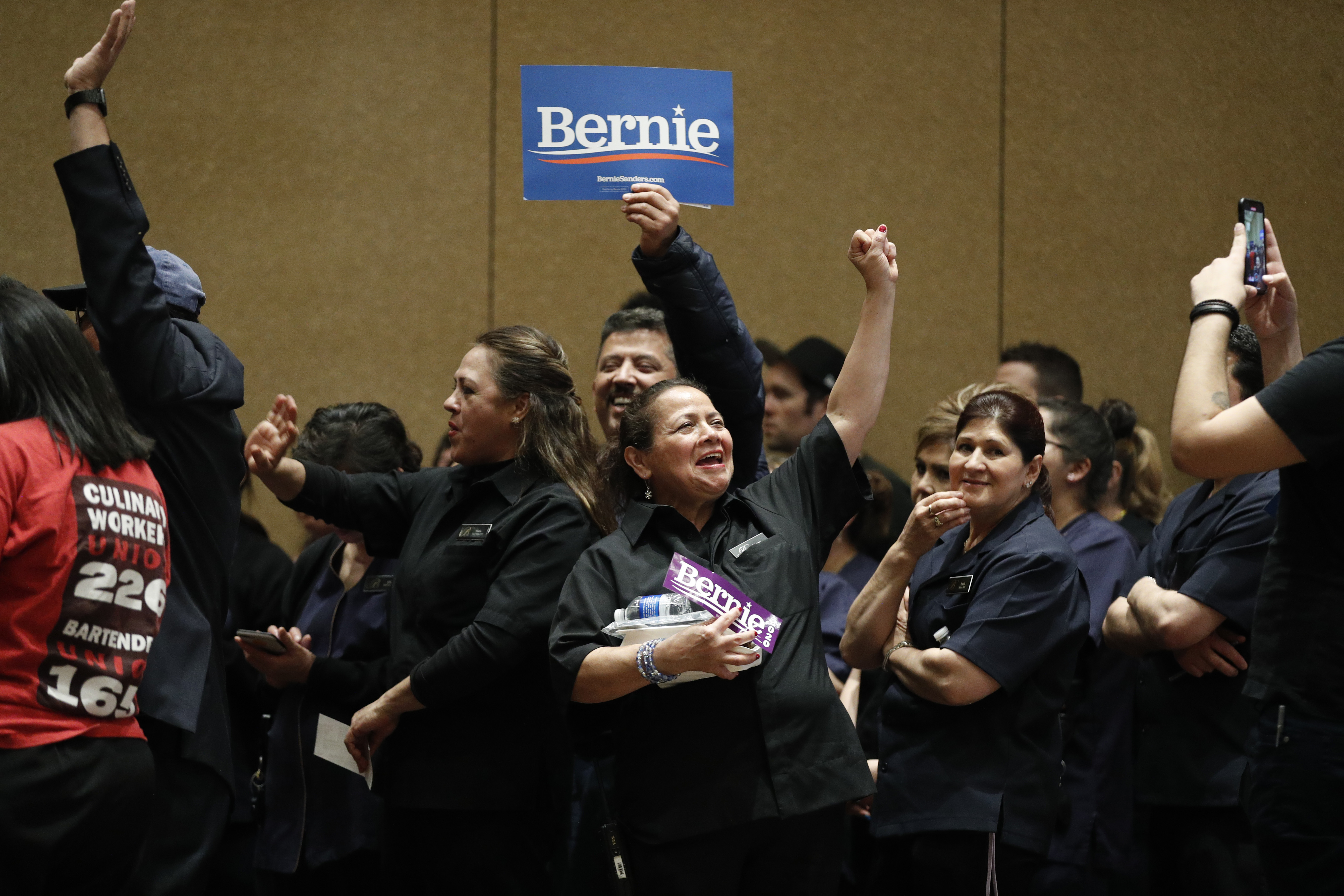 Supporters of Democratic presidential candidate Sen. Bernie Sanders, I-Vt., cheer as they caucus at the Bellagio hotel-casino, Saturday, Feb. 22, 2020, in Las Vegas. (AP Photo/John Locher)
