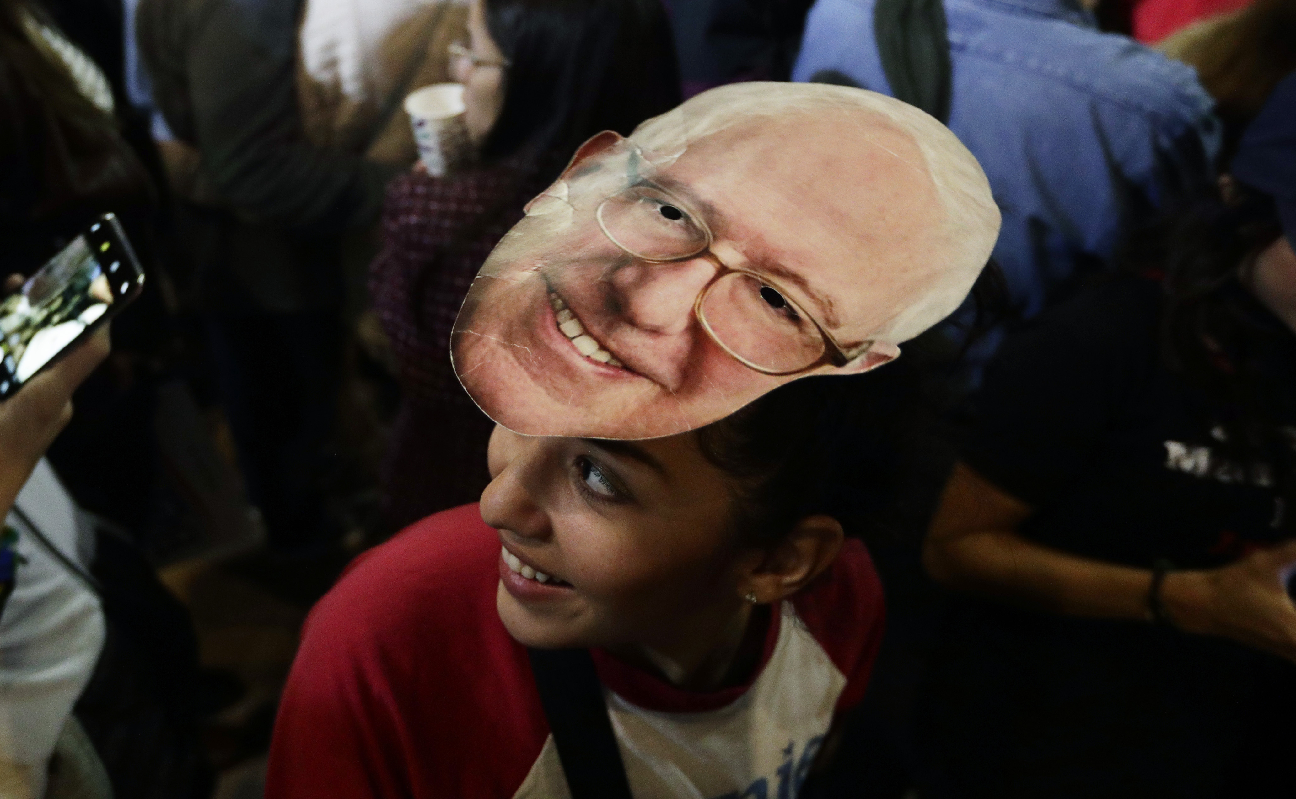 Michelle Nicoleq wears a Bernie Sanders mask as she attends a campaign event for Democratic presidential candidate Sen. Bernie Sanders, I-Vt., in San Antonio, Saturday, Feb. 22, 2020. (AP Photo/Eric Gay)