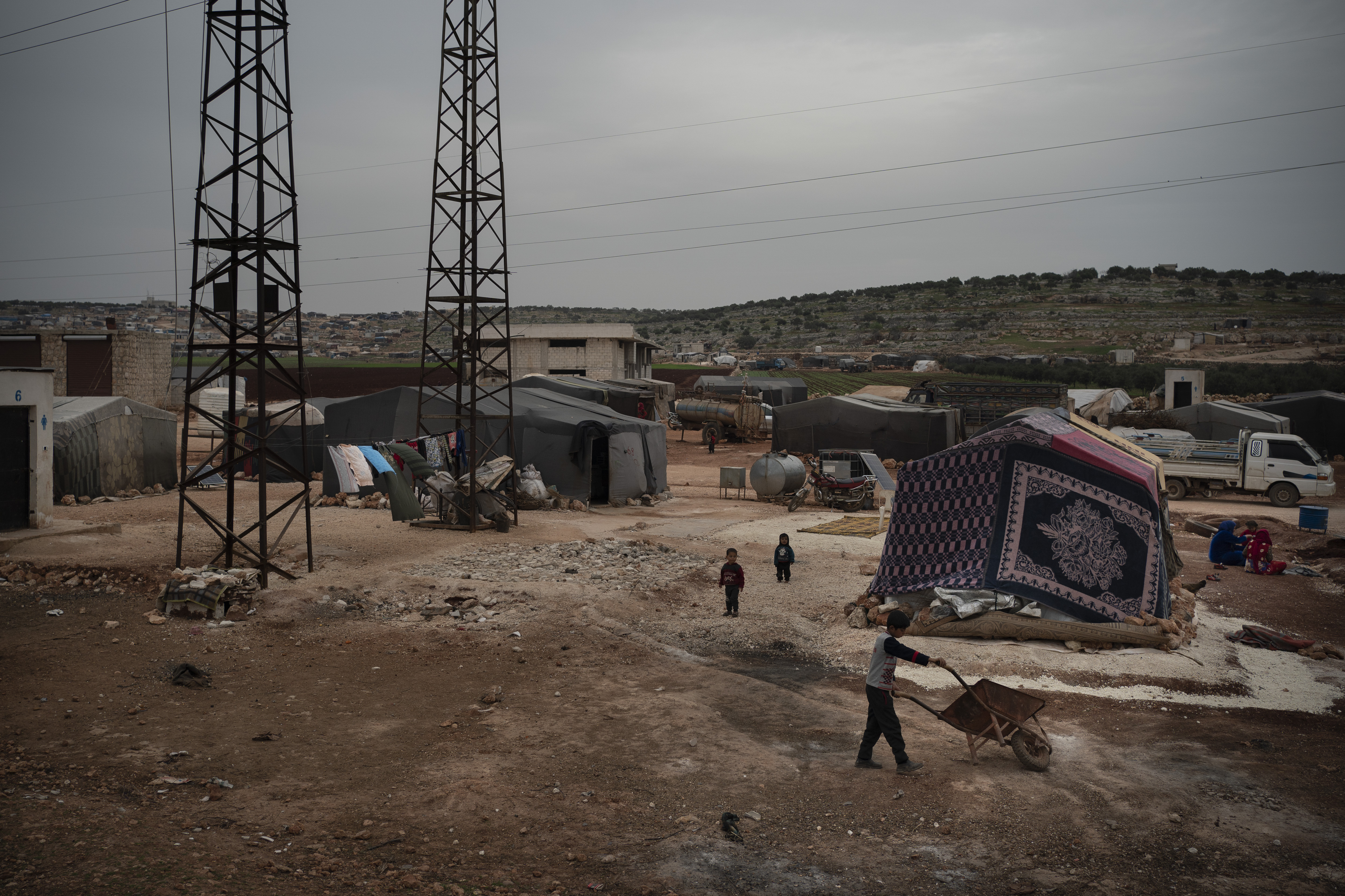 In this Thursday, March 12, 2020 photo, children play in an informal camp for people displaced by fighting outside of Idlib city, Syria. Idlib city is the last urban area still under opposition control in Syria, located in a shrinking rebel enclave in the northwestern province of the same name. Syria’s civil war, which entered its 10th year Monday, March 15, 2020, has shrunk in geographical scope -- focusing on this corner of the country -- but the misery wreaked by the conflict has not diminished. (AP Photo/Felipe Dana)