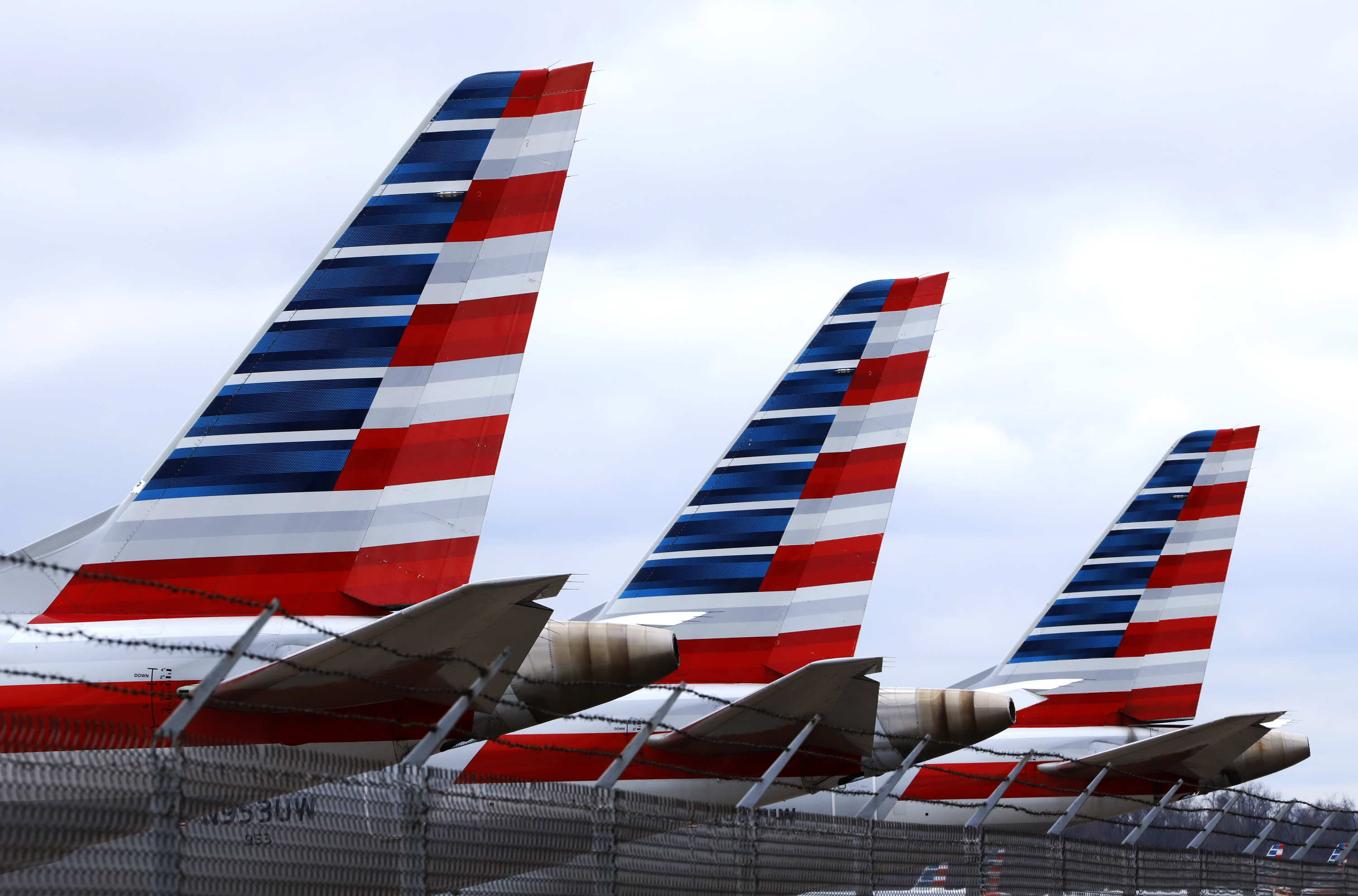 These are some of the 88 American Airlines planes stored at Pittsburgh International Airport in Imperial, Pa., on Tuesday, March 31, 2020. As airlines cut more service, due to the COVID-19 pandemic, Pittsburgh International Airport has closed one of its four runways to shelter in place 96 planes, mostly from American Airlines, as of Monday, March 30, 2020. The airport has the capacity to store 140 planes.(AP Photo/Gene J. Puskar)