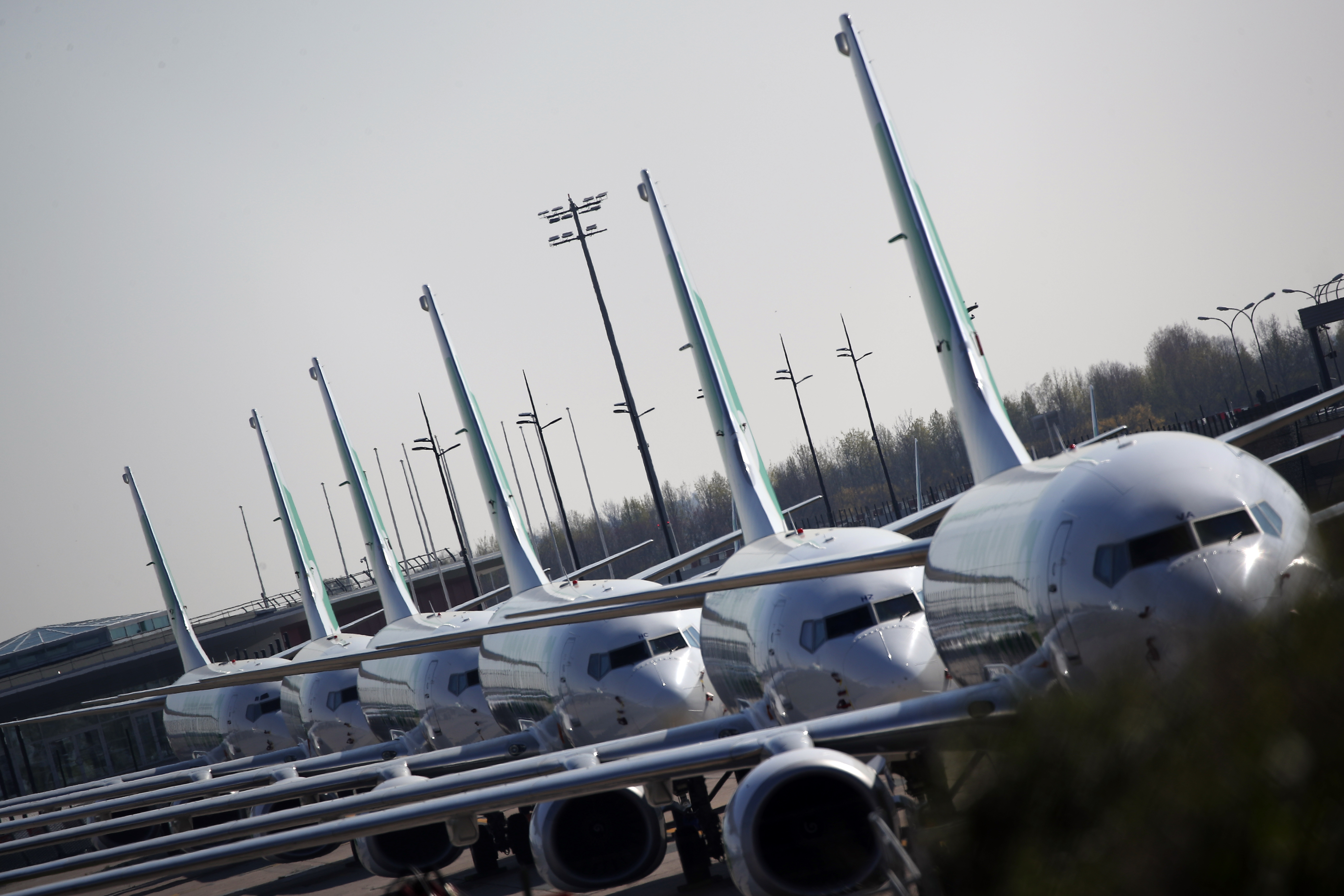 Airplanes are lined up on the tarmac at the international airport of Orly, the day of its closure due to a drop in traffic, in Orly, south of Paris, Wednesday, April 1, 2020 as the government announced an extension of the initial 15-day home confinement period that came into force on March 17 in a bid to brake the spread of the Covid-19. The new coronavirus causes mild or moderate symptoms for most people, but for some, especially older adults and people with existing health problems, it can cause more severe illness or death. (AP Photo/Francois Mori)