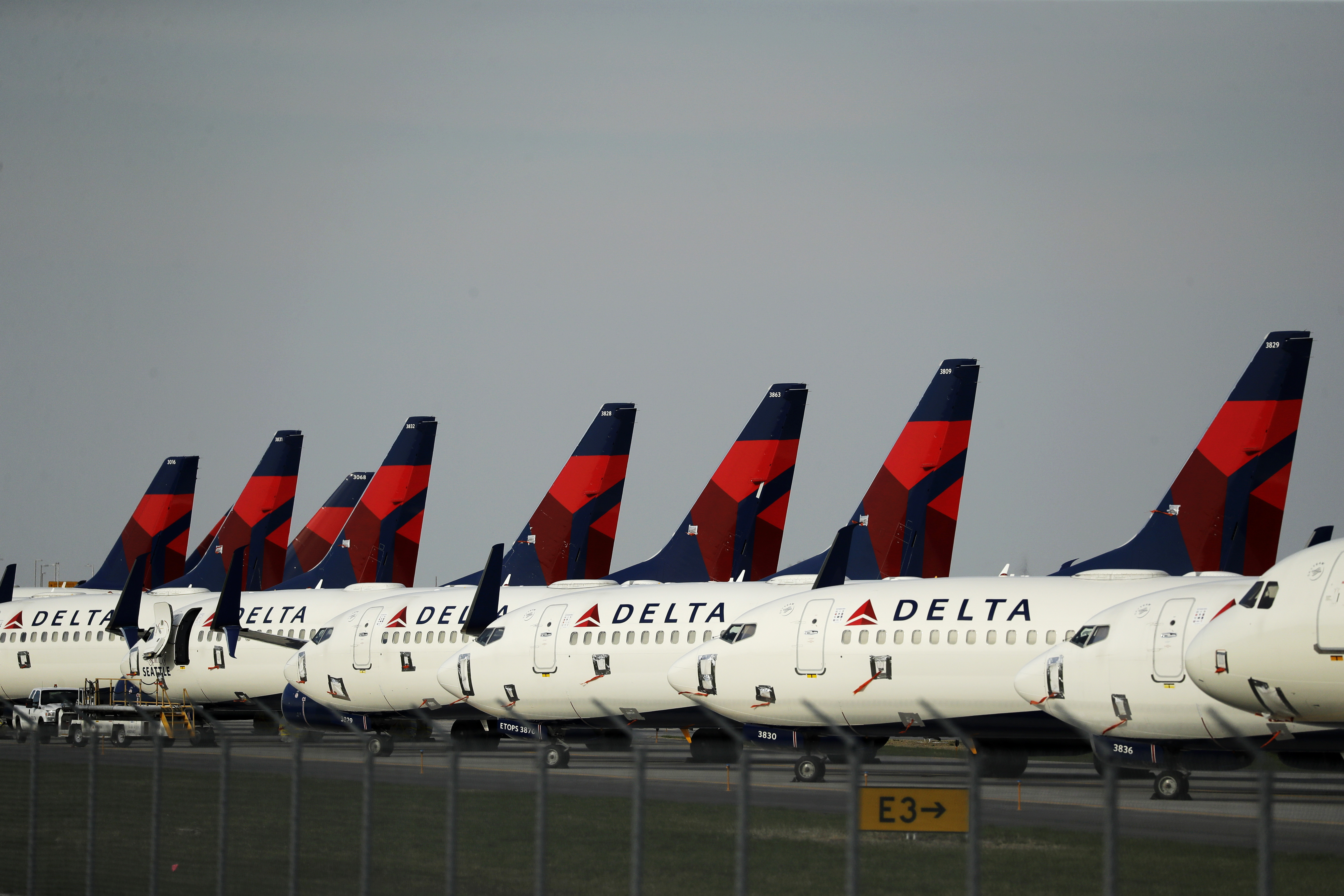 Several dozen mothballed Delta Air Lines jets are parked at Kansas City International Airport Wednesday, April 1, 2020 in Kansas City, Mo. The planes are among the thousands of passenger jets taken out of service worldwide as travel restrictions and stay-at-home orders due to the new coronavirus has drastically reduced air travel. (AP Photo/Charlie Riedel)