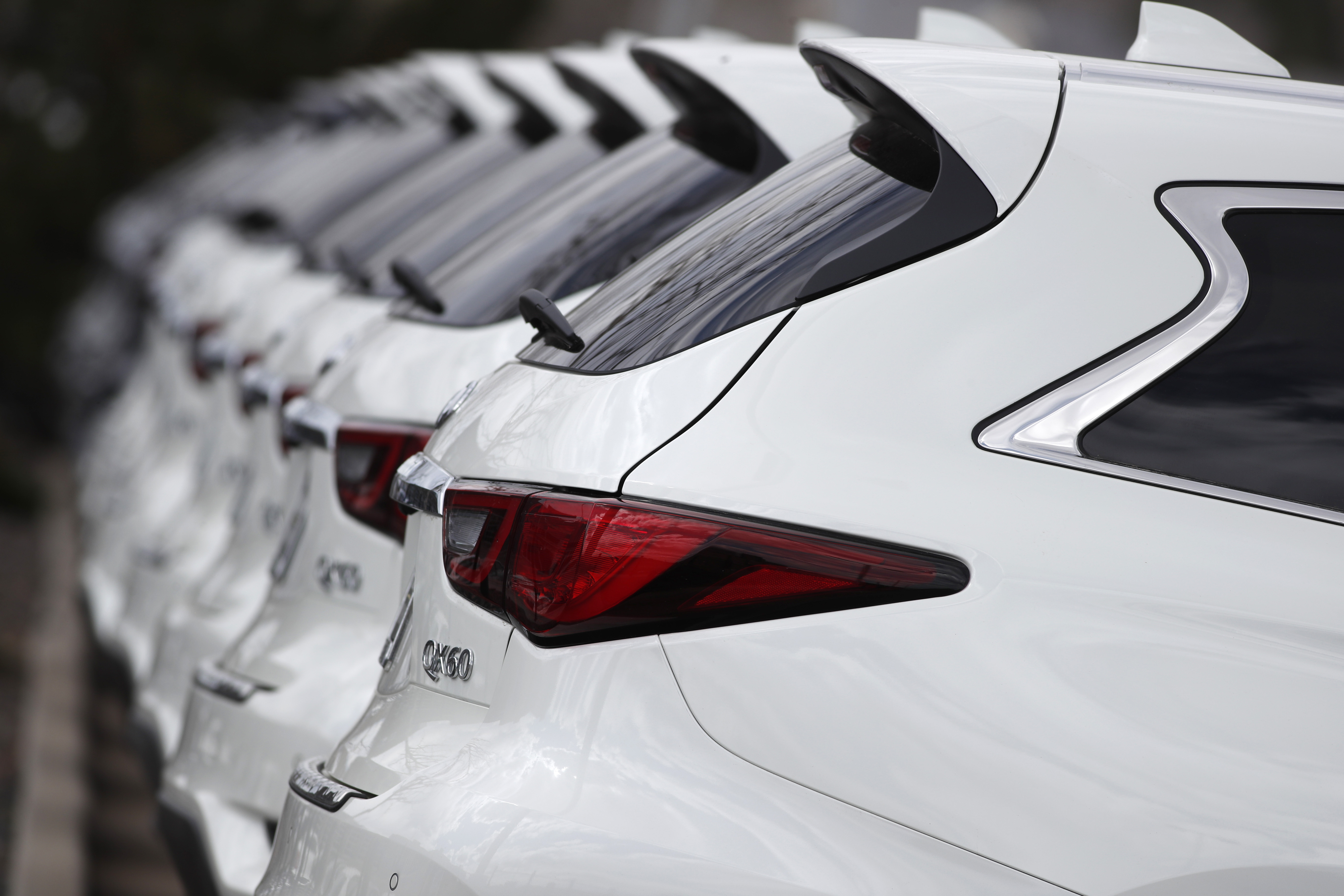 In this Sunday, April 5, 2020, photograph, a long row of 2020 QX60 sports-utility vehicles sits at an Infinti dealership in Highlands Ranch, Colo. (AP Photo/David Zalubowski)