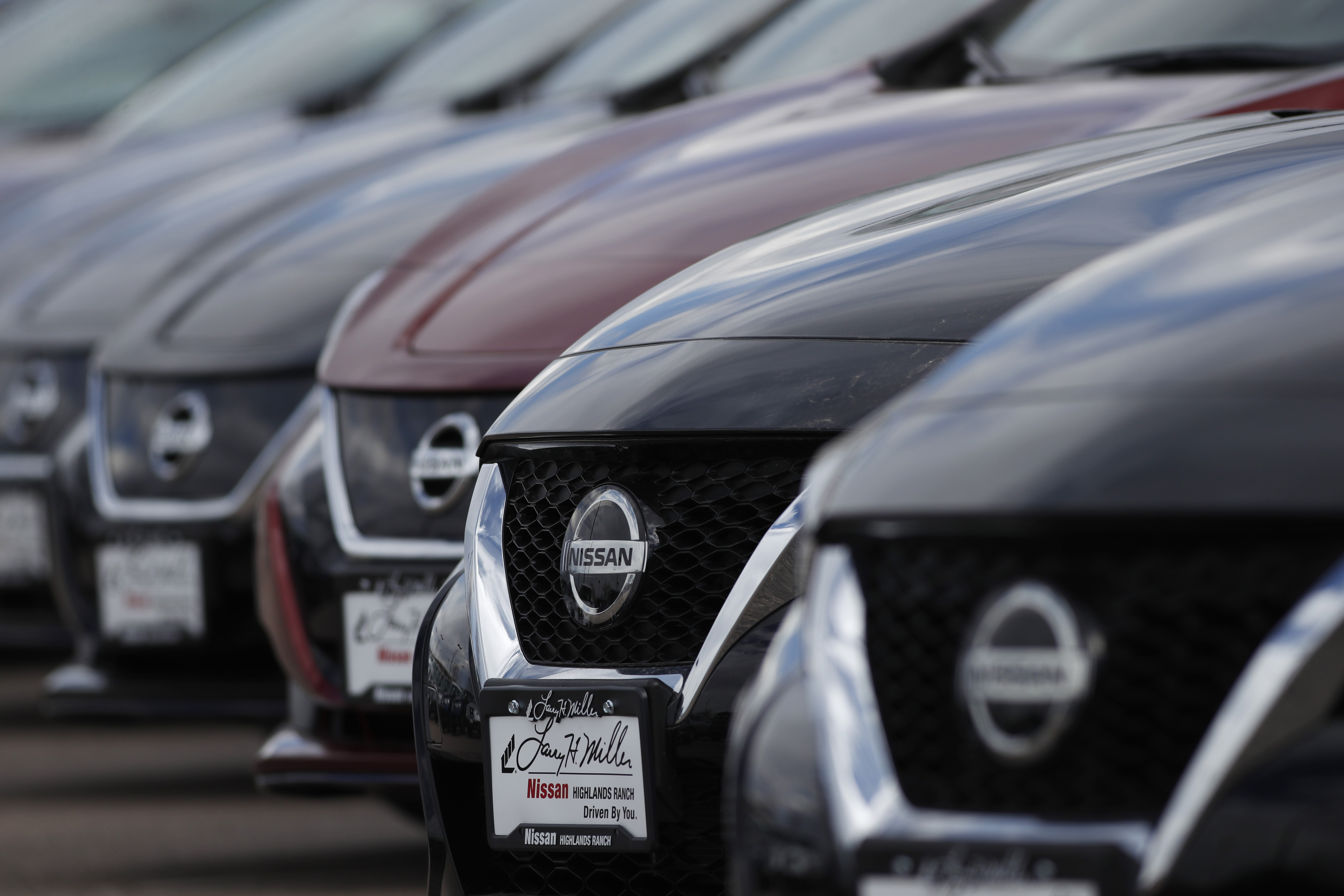 In this Sunday, April 5, 2020, photograph, a long row of unsold 2020 Altima sedans sits at a Nissan dealership in Highlands Ranch, Colo. (AP Photo/David Zalubowski)