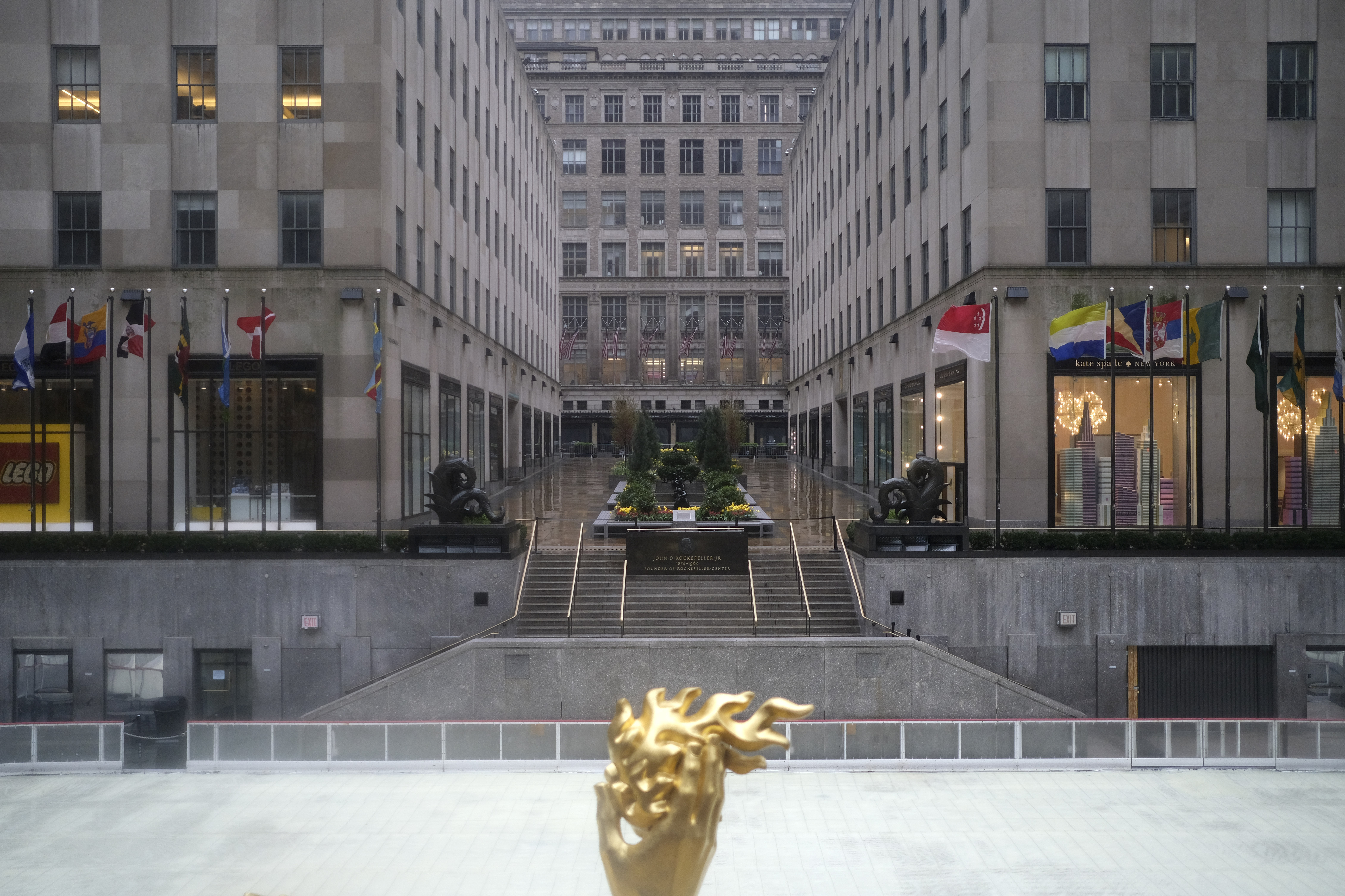 Rockefeller Center is empty on a rainy day in New York, Monday, April 13, 2020. Gov. Andrew Cuomo says New York's death toll from coronavirus has topped 10,000, with hospitals still seeing 2,000 new patients a day. The death tally hit the milestone only about a month after the state recorded its first death. (AP Photo/Seth Wenig)
