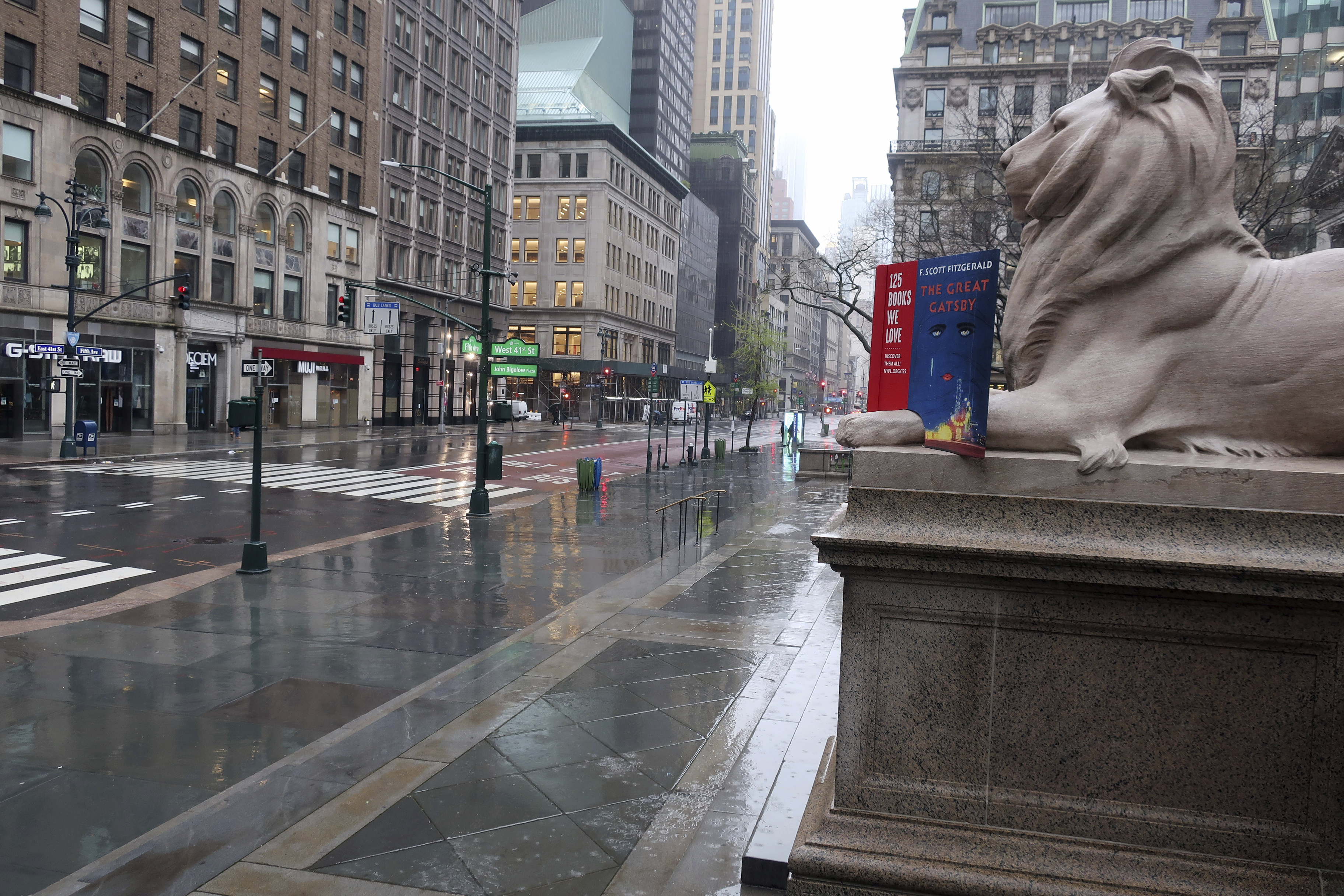 Fifth Avenue in front of the New York Public Library is empty on a rainy day in New York, Monday, April 13, 2020. Gov. Andrew Cuomo says New York's death toll from coronavirus has topped 10,000, with hospitals still seeing 2,000 new patients a day. (AP Photo/Ted Shaffrey)