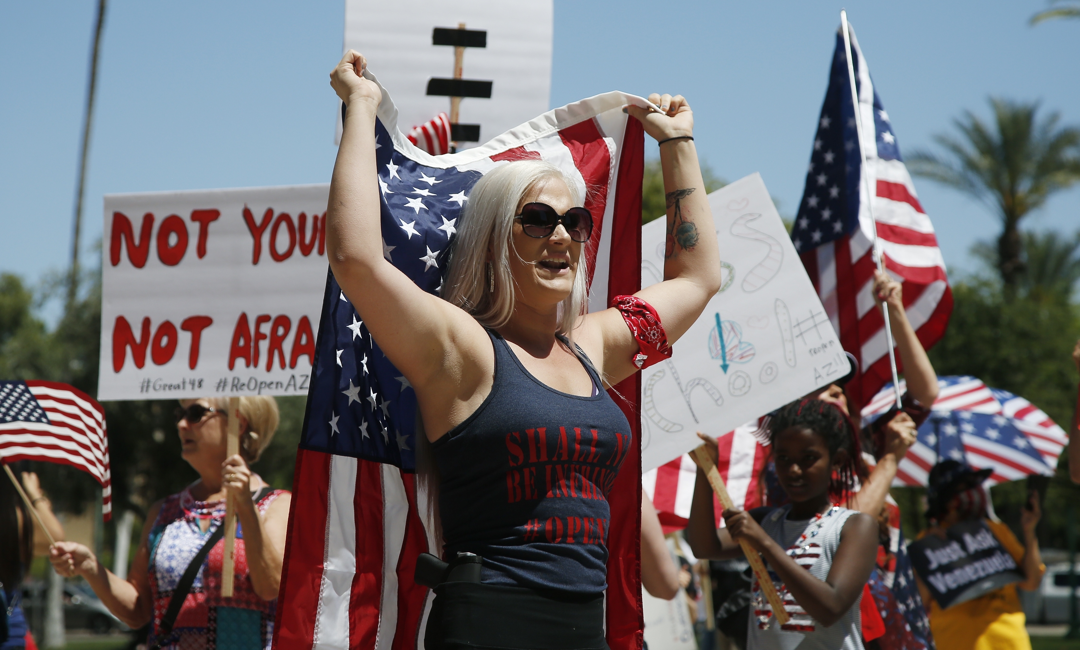 Protesters rally at the state Capitol to 're-open' Arizona against the governor's stay-at-home order due to the coronavirus Monday, April 20, 2020, in Phoenix. (AP Photo/Ross D. Franklin)