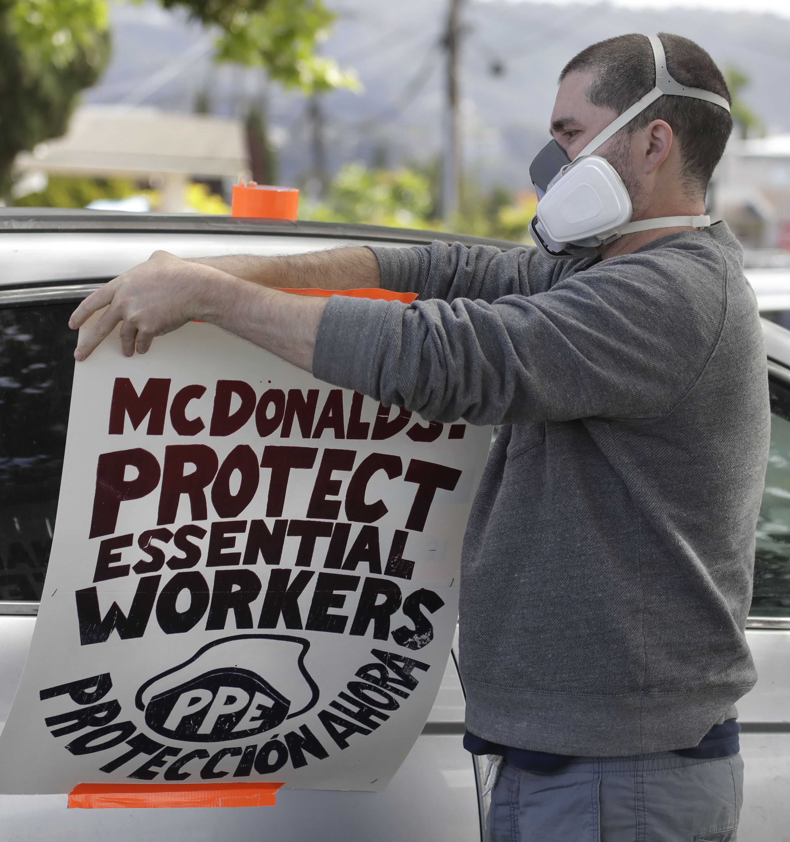 A man protests what he claims is a lack of personal protective equipment for McDonald's employees on Tuesday, April 21, 2020, in Oakland, Calif. (AP Photo/Ben Margot)