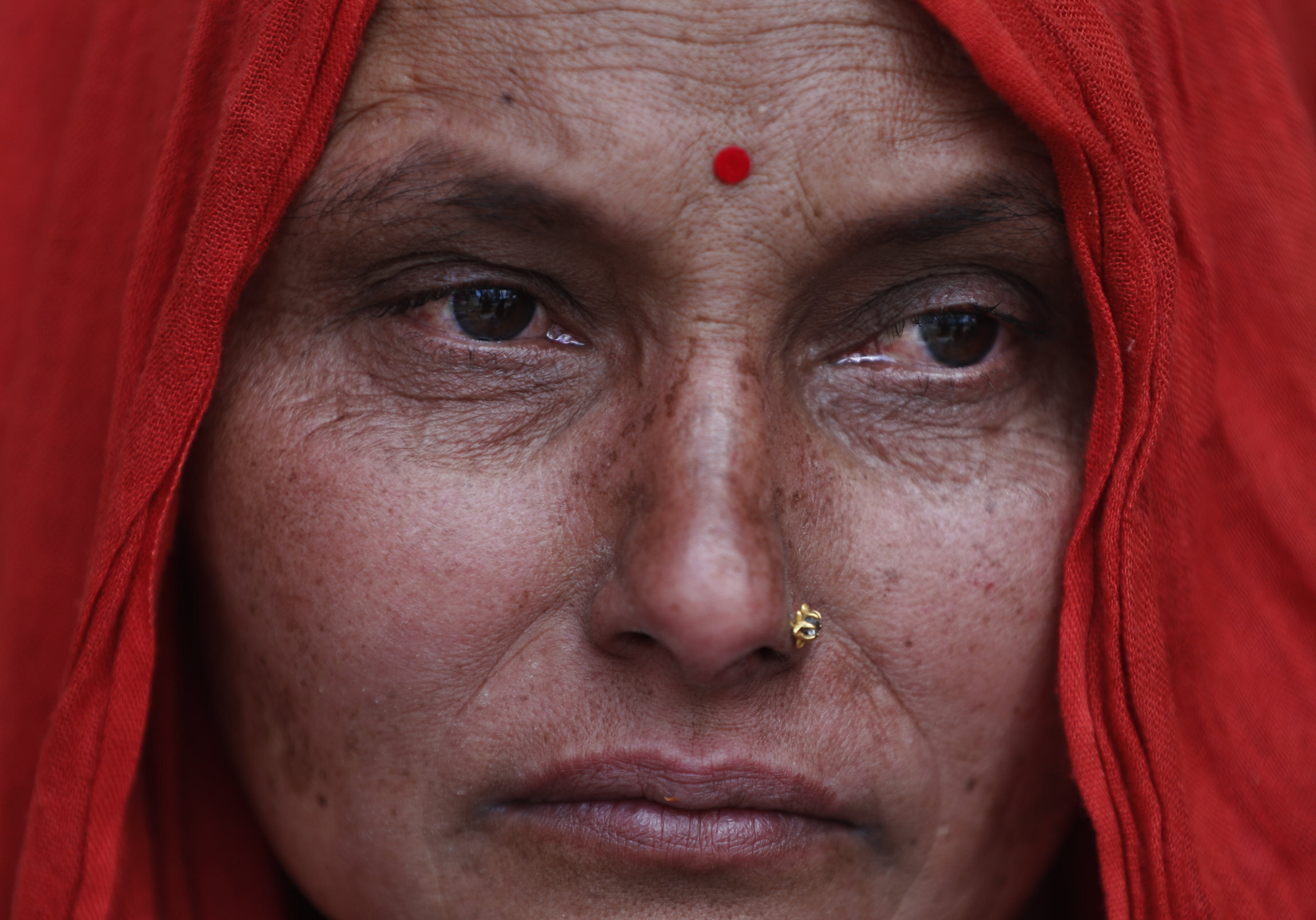 Sita Adhikari, 44, a cancer patient cries while she waits for a vehicle to go back to her village, during lockdown to prevent the spread of the new coronavirus in Bhaktapur, Nepal, Monday, April 20, 2020. The supreme court passed an interim order on Friday instructing the Nepalese government to ensure free transportation for stranded daily wage workers and others making the long journey back to their respective villages on foot. (AP Photo/Niranjan Shrestha)