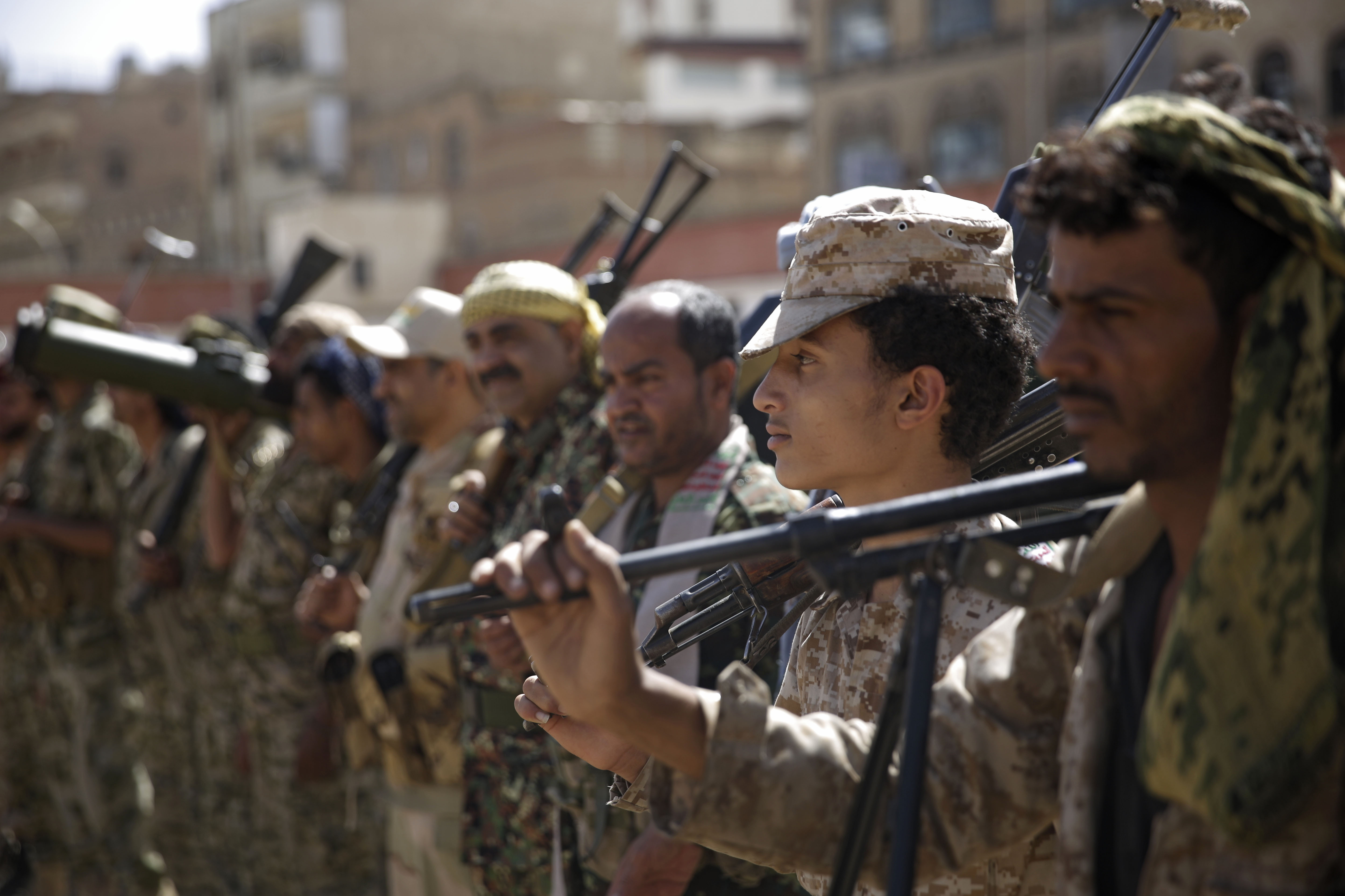 Houthi rebel fighters display their weapons during a gathering aimed at mobilizing more fighters for the Iranian-backed Houthi movement, in Sanaa, Yemen, Thursday, Feb. 20, 2020. The Houthi rebels control the capital, Sanaa, and much of the country’s north, where most of the population lives. They are at war with a U.S.-backed, Saudi-led coalition fighting on behalf of the internationally recognized government. (AP Photo/Hani Mohammed)