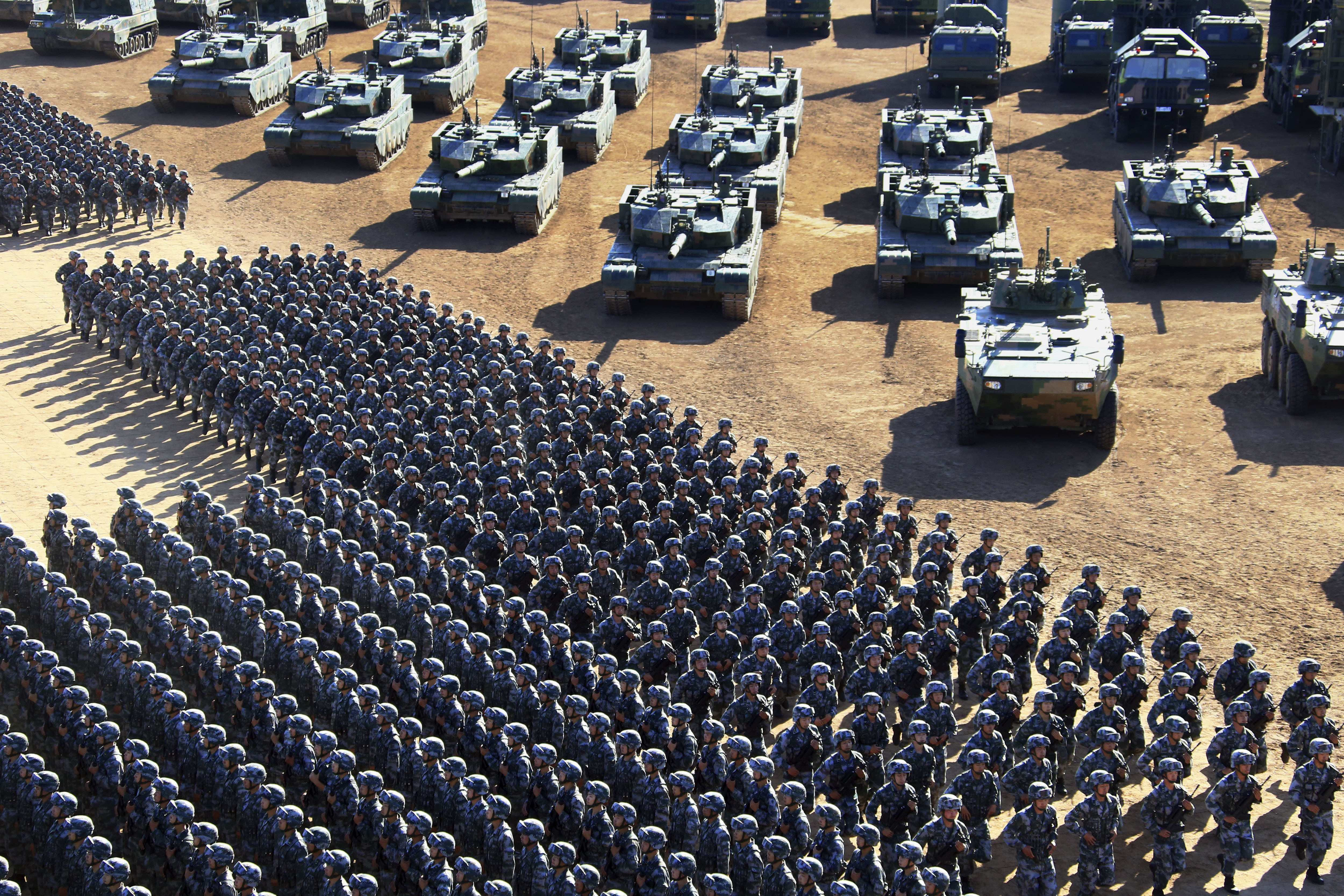 CORRECTS DATE PHOTO TAKEN - In this photo released by China's Xinhua News Agency, Chinese People's Liberation Army (PLA)  troops march past military vehicles Sunday, July 30, 2017 as they arrive for a military parade to commemorate the 90th anniversary of the founding of the PLA on Aug. 1 at Zhurihe training base in north China's Inner Mongolia Autonomous Region. (Zha Chunming/Xinhua via AP)