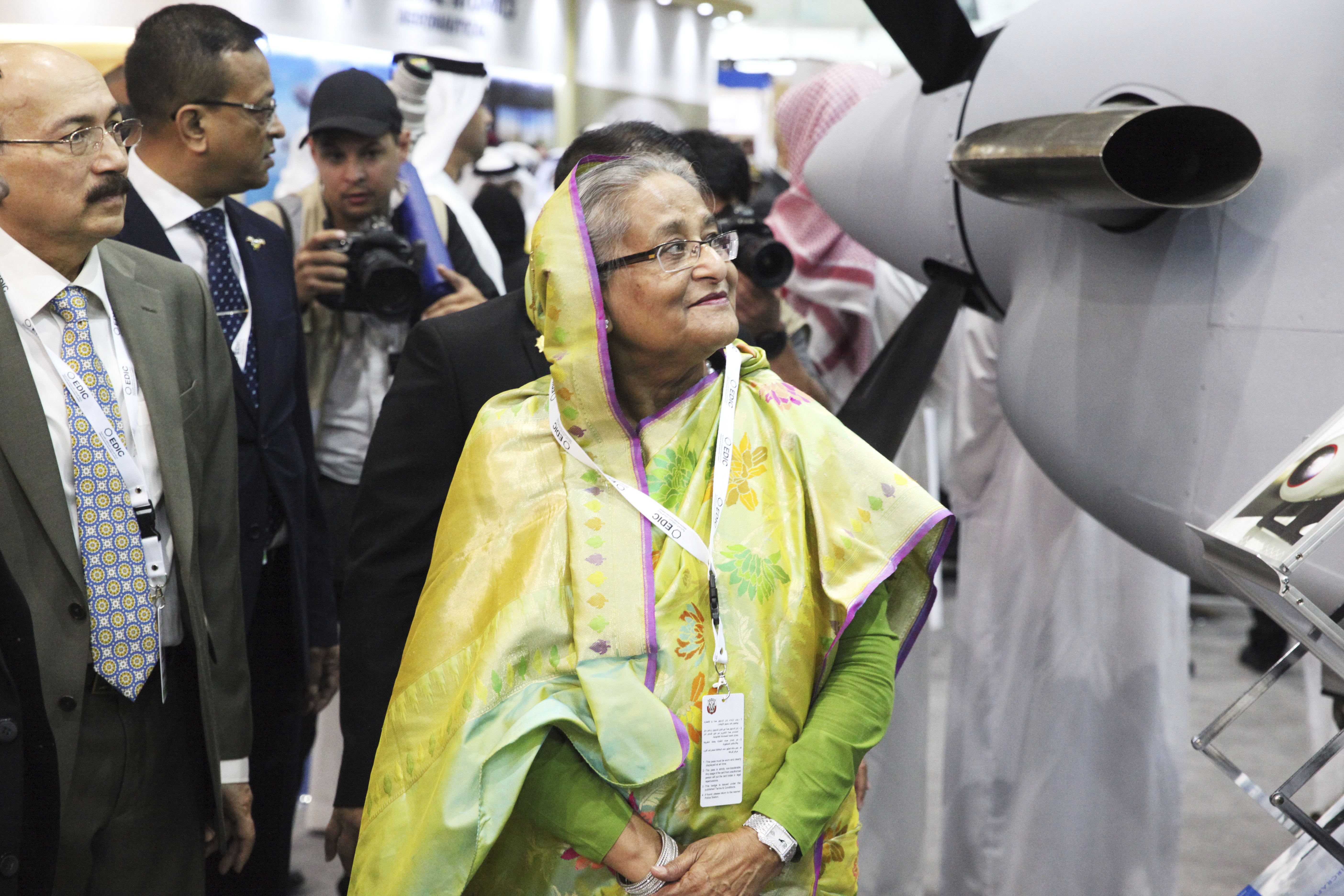 Bangladesh Prime Minister Sheikh Hasina examines a display at the International Defense Exhibition and Conference in Abu Dhabi, United Arab Emirates, Sunday, Feb. 17, 2019. The biennial arms show in Abu Dhabi comes as the United Arab Emirates faces increasing criticism for its role in the yearlong war in Yemen. (AP Photo/Jon Gambrell)