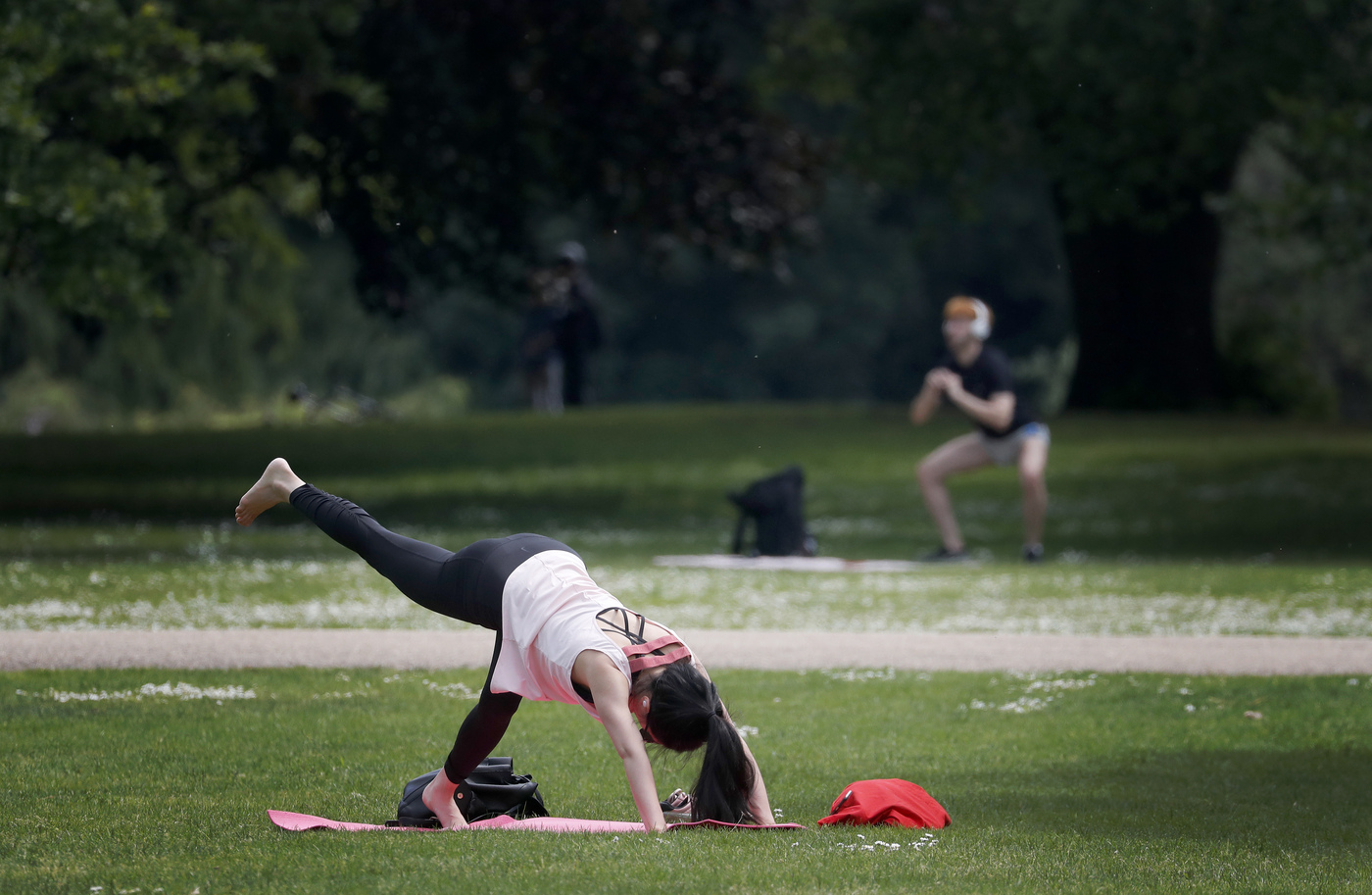 People exercise in St James Park in London, Sunday, May 10, 2020 during the nation-wide coronavirus lockdown. Personal exercise while observing social distancing measures is allowed under government lockdown guidelines. (AP Photo/Frank Augstein)