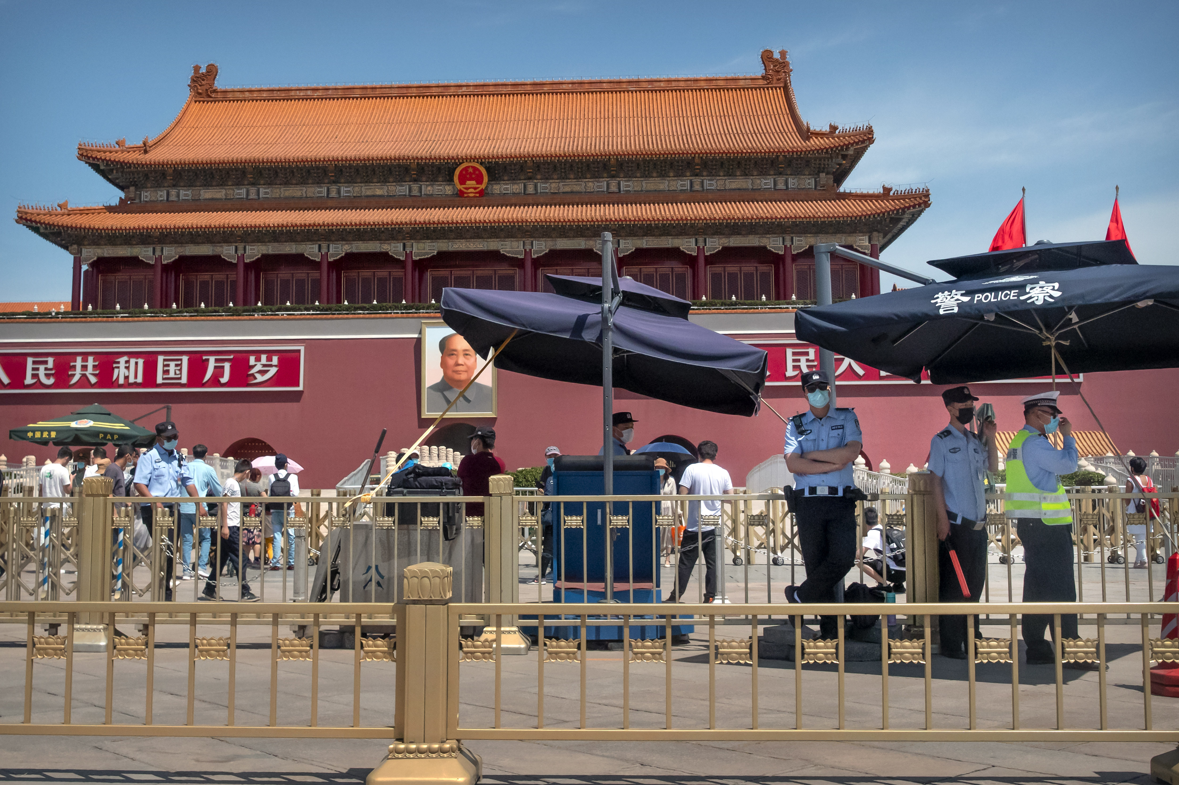 In this Wednesday, May 20, 2020, photo, Chinese police stand guard in front of Tiananmen Gate in Beijing. This year's version of China's biggest political meeting of the year will be unlike any other. Delayed from March because of the then-spiraling coronavirus outbreak, the decision to go ahead with the gathering signals a partial return to normalcy in the country where the pandemic first broke out. 