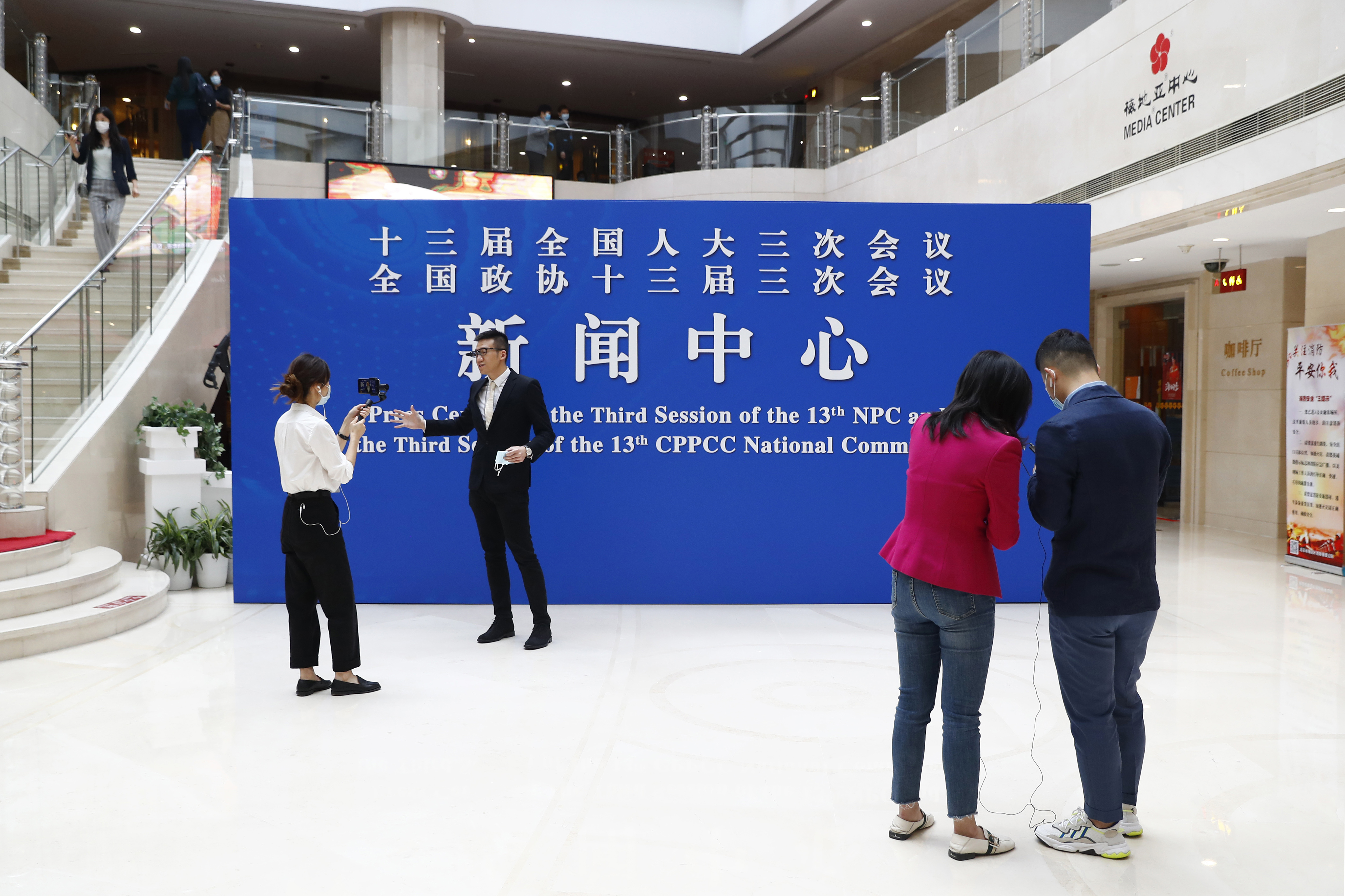 Journalists wearing face masks to help curb the spread of the coronavirus gather at the media center before a news conference by Guo Weimin, spokesman for the National Committee of the Chinese People's Political Consultative Conference (CPPCC), in Beijing, Wednesday, May 20, 2020. (Thomas Peter/Pool Photo via AP)