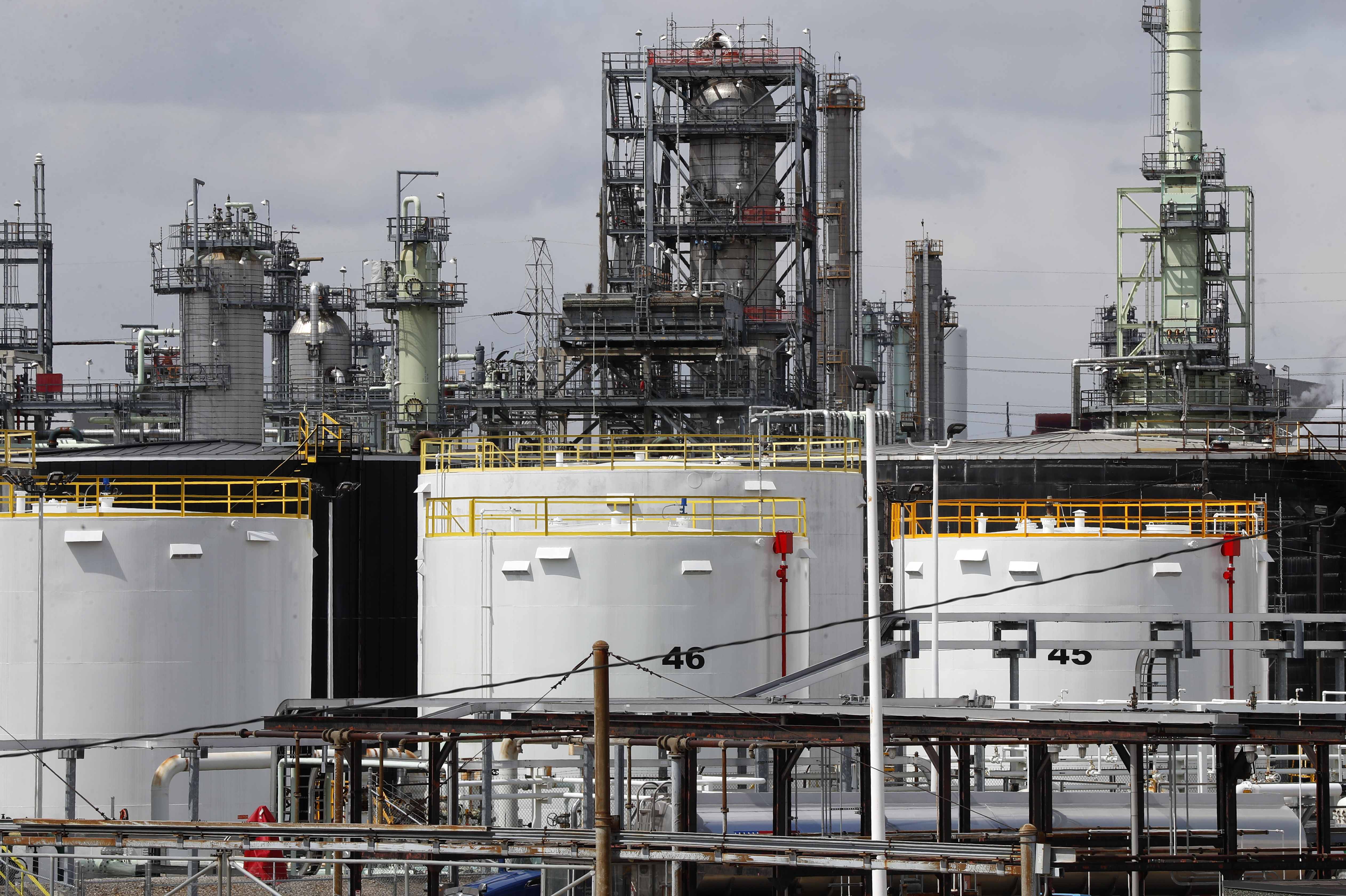 Storage tanks are shown at the Marathon Petroleum Corp. refinery in Detroit, Tuesday, April 21, 2020. The world is awash in oil, there's little demand for it and we're running out of places to put it. That in a nutshell explains this week's strange and unprecedented action in the market for crude oil futures contracts, where traders essentially offered to pay someone else to deal with the oil they were due to have delivered next month.(AP Photo/Paul Sancya)