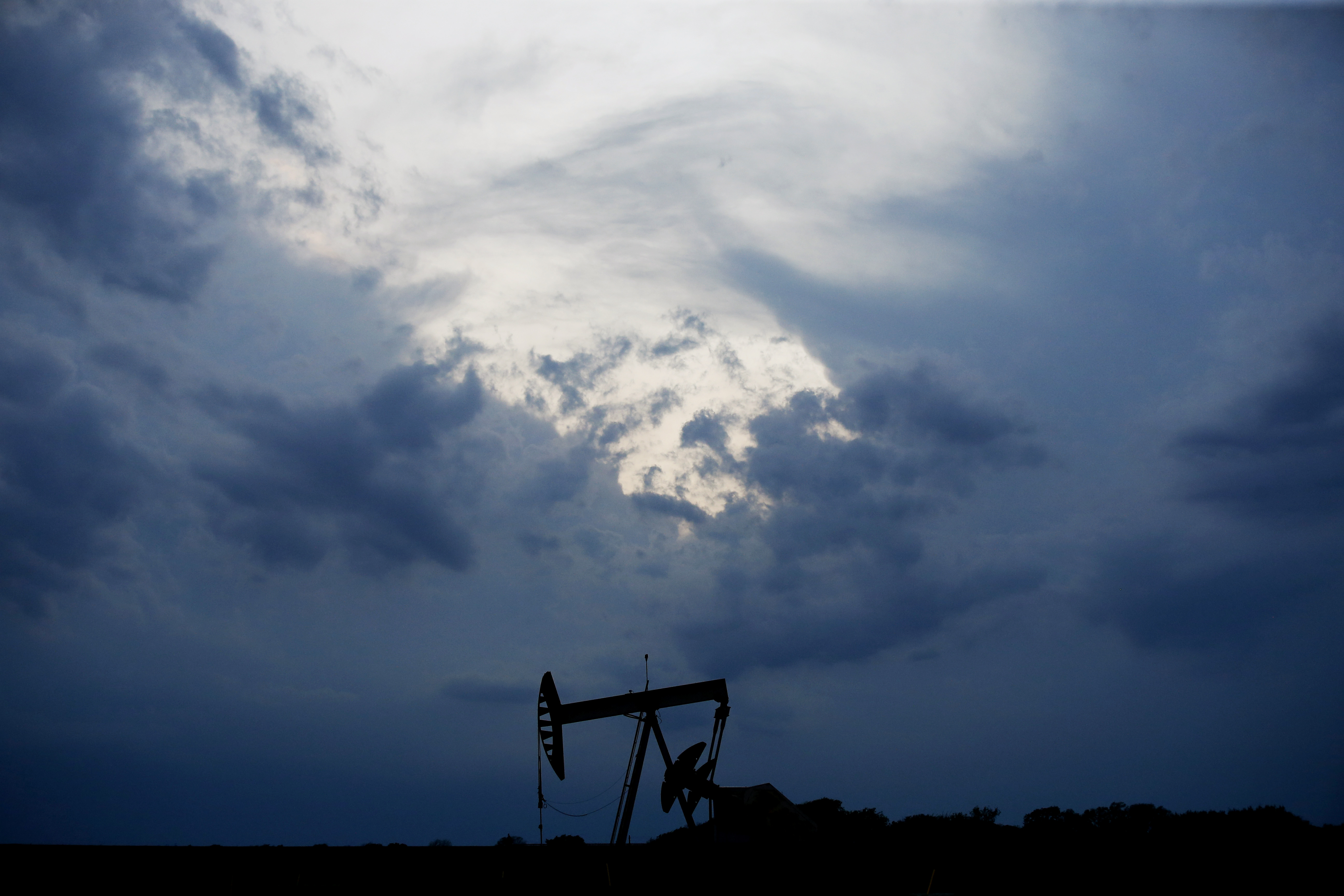 A pumpjack is pictured as a storm moves in Tuesday, April 21, 2020, in Oklahoma City. Oil prices continue to drop, because very few people are flying or driving, and factories have shut amid widespread stay-at-home orders due to the coronavirus cencerns. (AP Photo/Sue Ogrocki)