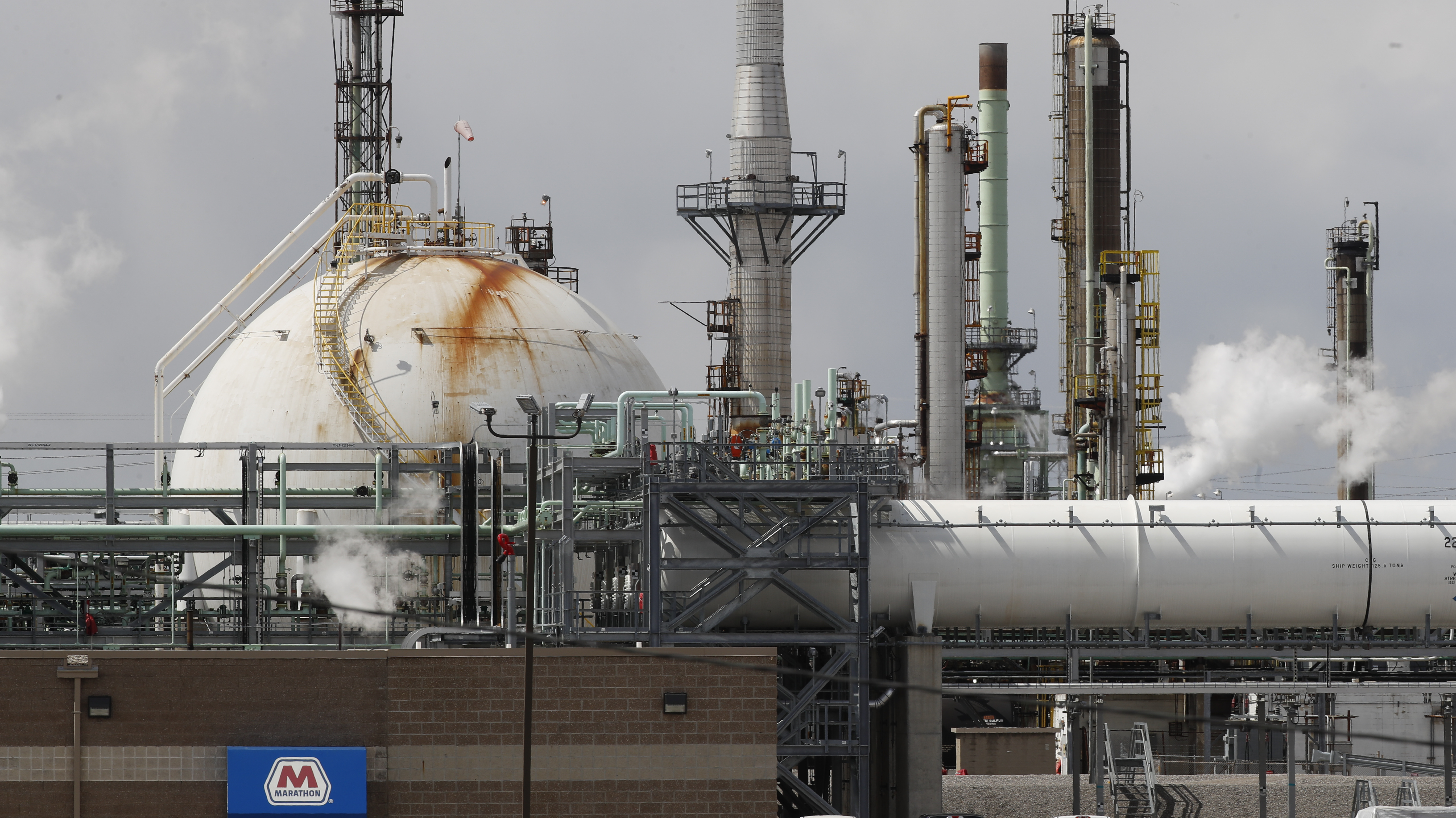 Storage is shown at the Marathon Petroleum Corp. refinery in Detroit, Tuesday, April 21, 2020. The world is awash in oil, there's little demand for it and we're running out of places to put it. That in a nutshell explains this week's strange and unprecedented action in the market for crude oil futures contracts, where traders essentially offered to pay someone else to deal with the oil they were due to have delivered next month.(AP Photo/Paul Sancya)