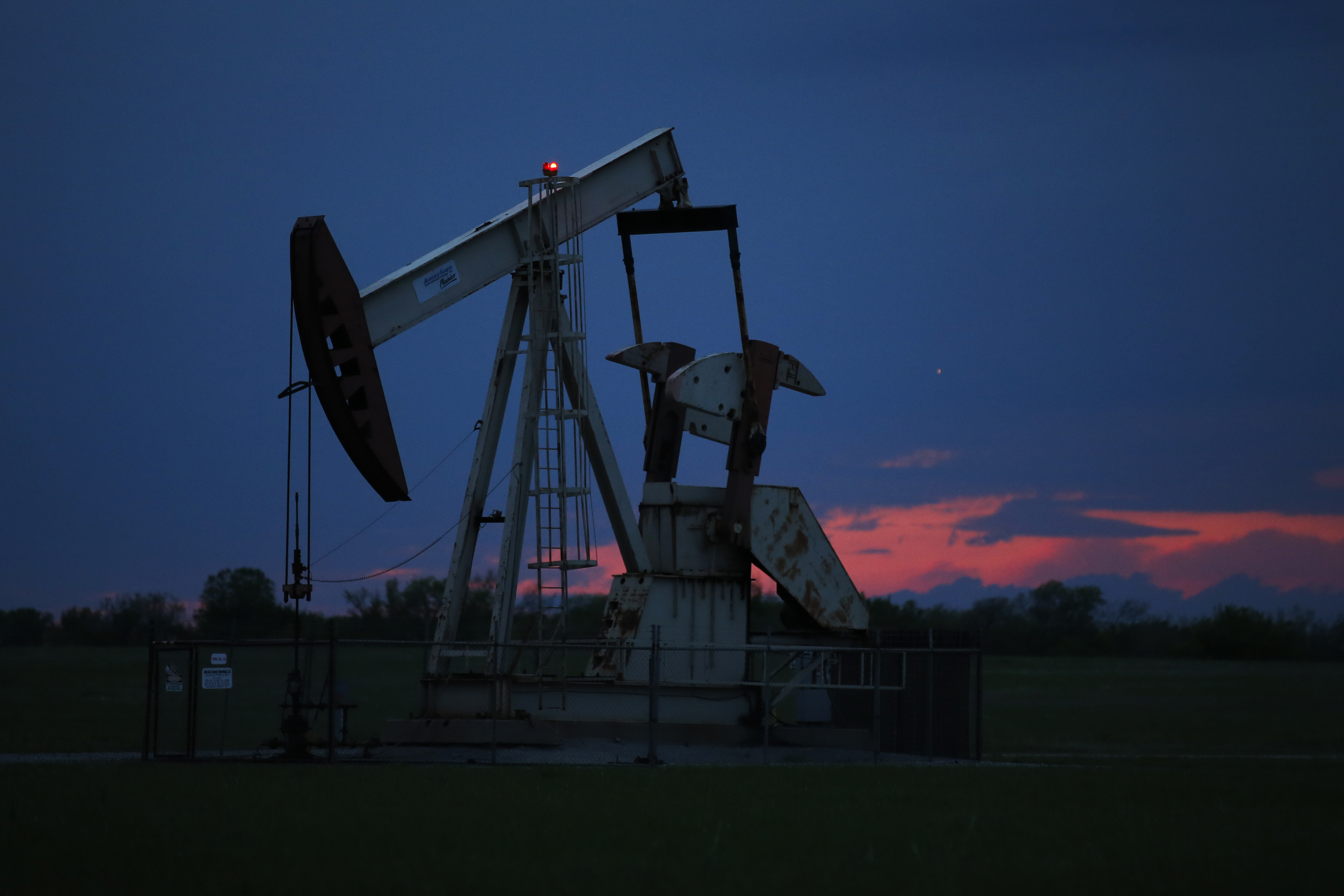 A pumpjack is pictured as the sun sets Tuesday, April 21, 2020, in Oklahoma City. Oil prices continue to drop, because very few people are flying or driving, and factories have shut amid widespread stay-at-home orders due to coronavirus concerns. (AP Photo/Sue Ogrocki)