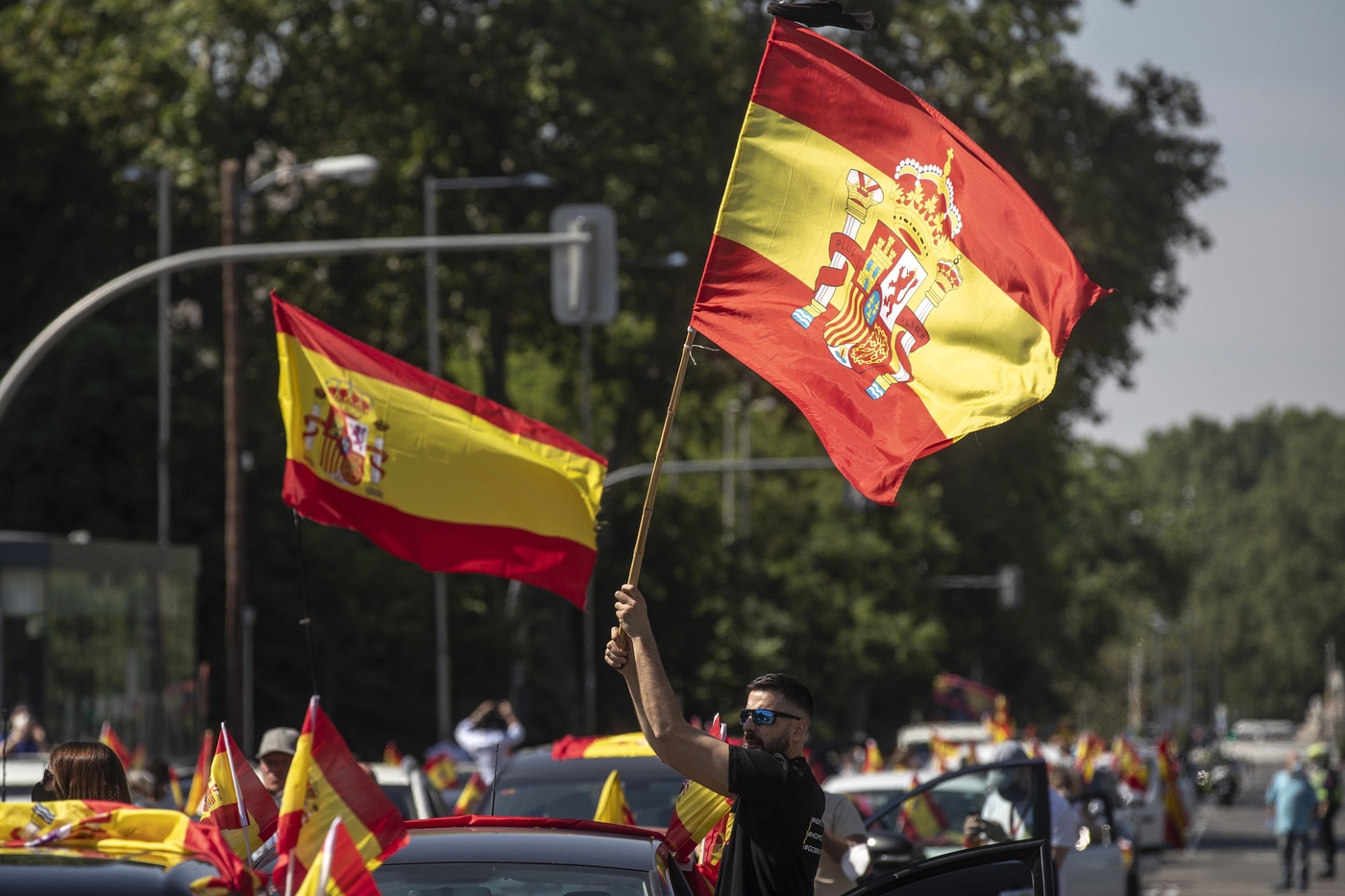 People wave Spanish flags during a drive-in protest organised by Spain's far-right party Vox against the Spanish government's handling of the nation's coronavirus outbreak in Madrid, Spain Saturday, May 23, 2020. (AP Photo/Manu Fernandez)