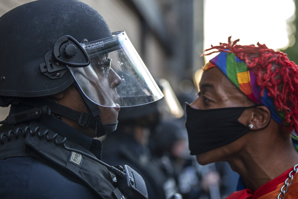 A protester confronts police during a rally in downtown Lexington, Ky., against the deaths of George Floyd and Breonna Taylor on Sunday, May 31, 2020. (Ryan C. Hermens/Lexington Herald-Leader via AP)
