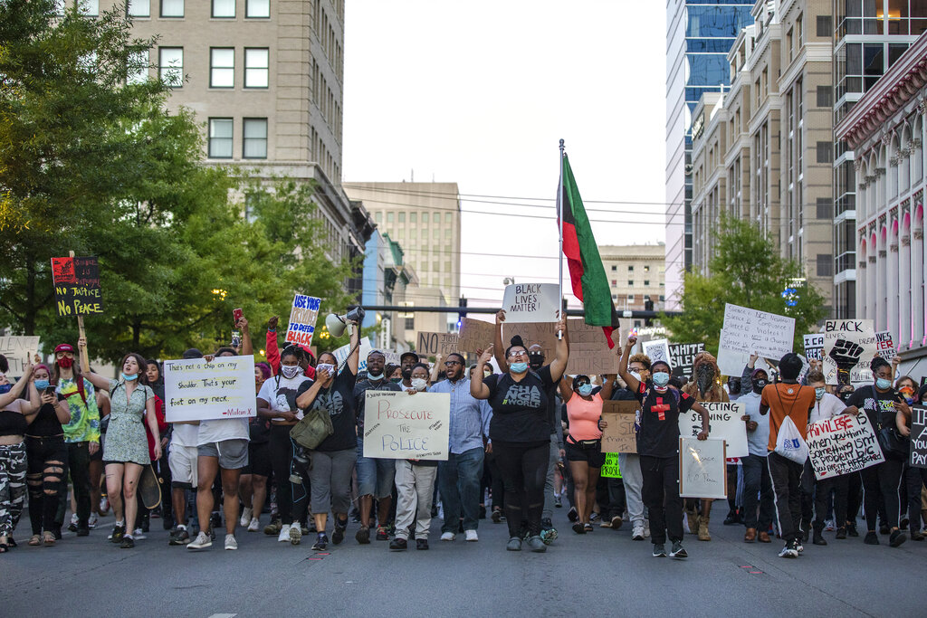 Protesters walk down Main Street in Lexington, Ky., during a rally against the deaths of George Floyd and Breonna Taylor on Sunday, May 31, 2020. (Ryan C. Hermens/Lexington Herald-Leader via AP)