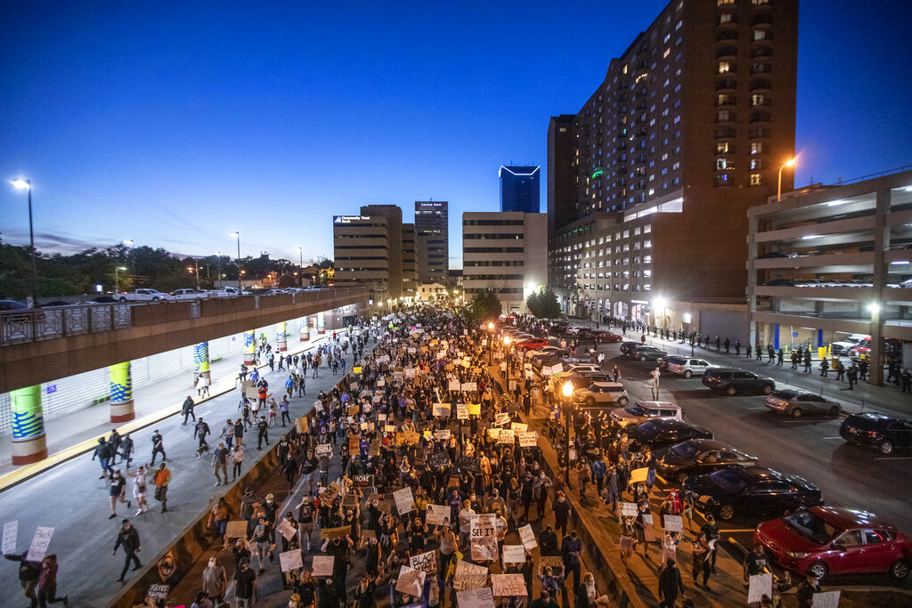 Protesters walk down East Vine Street in Lexington, Ky., during a rally against the deaths of George Floyd and Breonna Taylor on Sunday, May 31, 2020. (Ryan C. Hermens/Lexington Herald-Leader via AP)