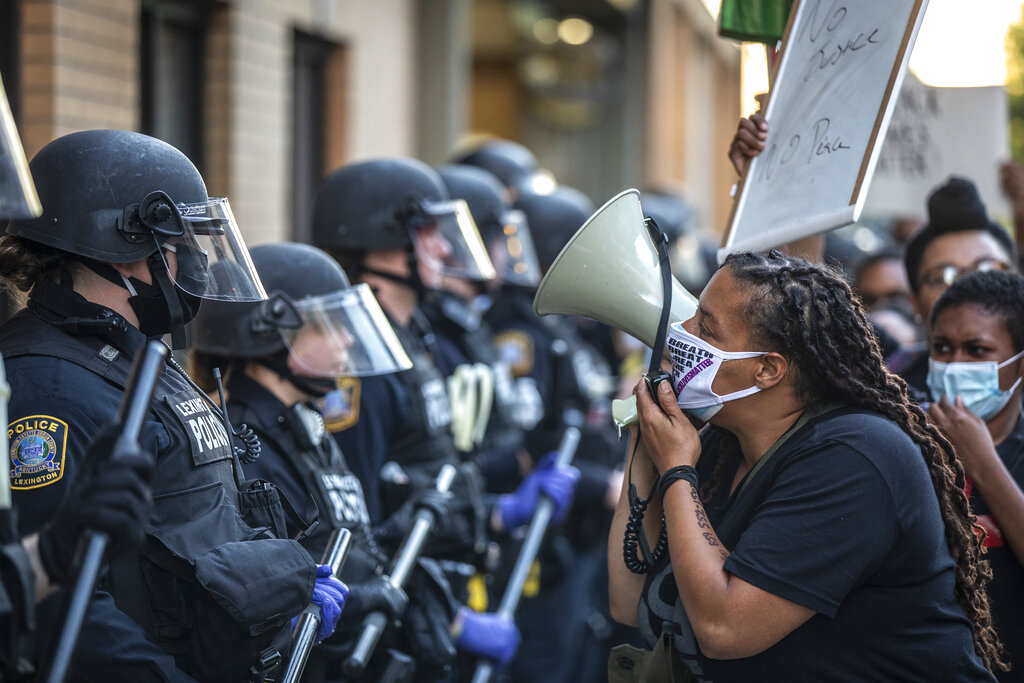 A protester confronts police during a rally in downtown Lexington, Ky., against the deaths of George Floyd and Breonna Taylor on Sunday, May 31, 2020. (Ryan C. Hermens/Lexington Herald-Leader via AP)