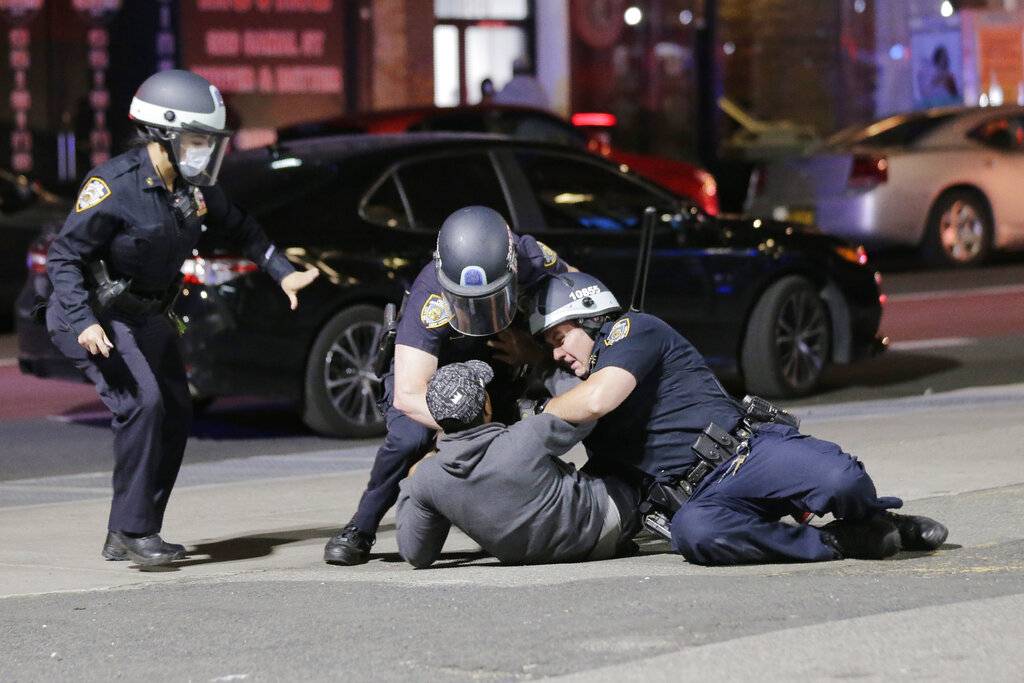 Police officers tackle a suspect trying to escape in New York, Monday, June 1, 2020. A fourth day of protests against police brutality kept New York City on edge Sunday, as thousands of people marched and many protesters and officers tried to keep the peace after days of unrest that left police cars burned and hundreds of people under arrest. (AP Photo/Seth Wenig)