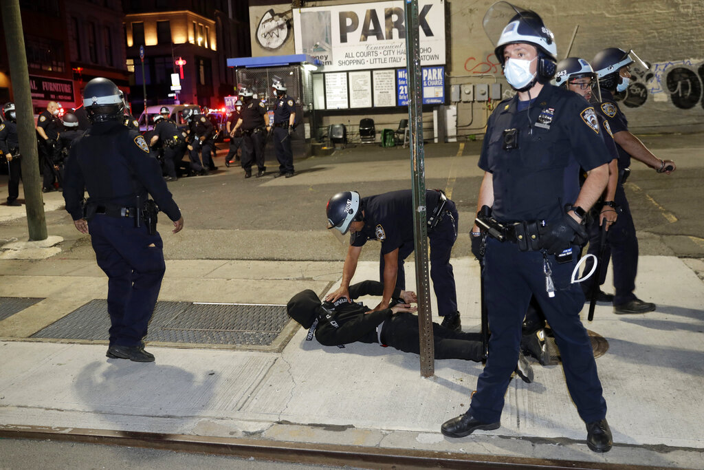 Police officers cuff a suspect in New York, Monday, June 1, 2020. A fourth day of protests against police brutality kept New York City on edge Sunday, as thousands of people marched and many protesters and officers tried to keep the peace after days of unrest that left police cars burned and hundreds of people under arrest. (AP Photo/Seth Wenig)