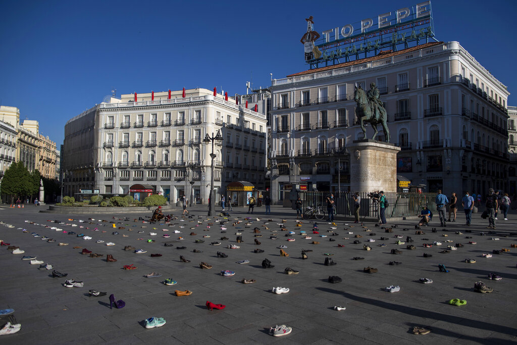 Shoes are displayed during a performance of the group Members of Extinction Rebellion 