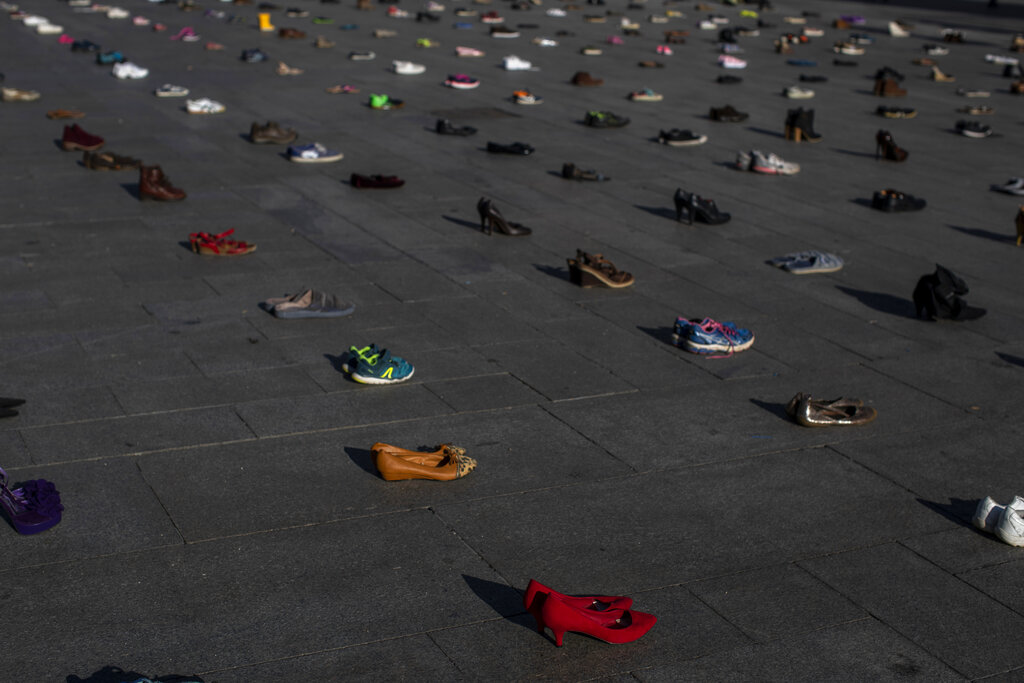Shoes are scattered on the ground during a performance of the group Members of Extinction Rebellion 