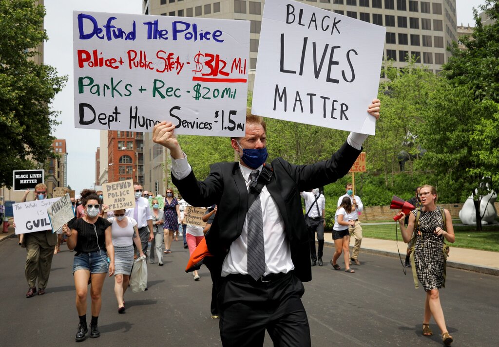 Matthew Mahaffey, a lawyer with Missouri Public Defenders, leads a protest march with Erika Wurst, right, in support of Black Lives Matter on Monday, June 8, 2020, from the appellate courthouse to the the Thomas F. Eagleton U.S. Courthouse in downtown St. Louis. (Christian Gooden/St. Louis Post-Dispatch via AP)