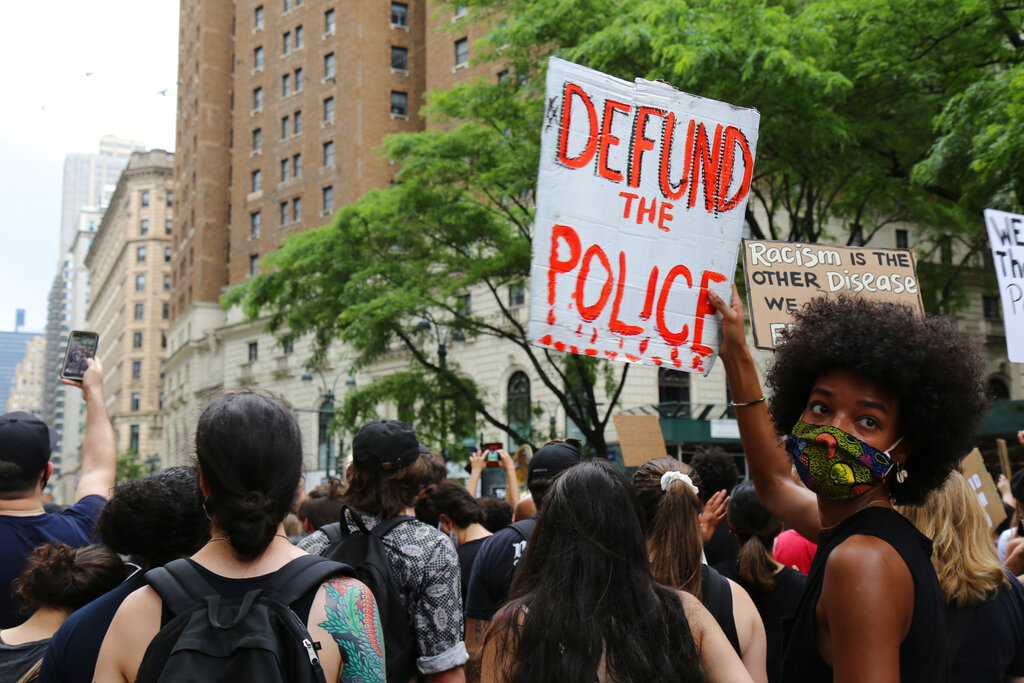 FILE - In this June 6, 2020, file photo, protesters march in New York. Since Floyd’s killing, police departments have banned chokeholds, Confederate monuments have fallen and officers have been arrested and charged. The moves come amid a massive, nationwide outcry against violence by police and racism. (AP Photo/Ragan Clark, File)