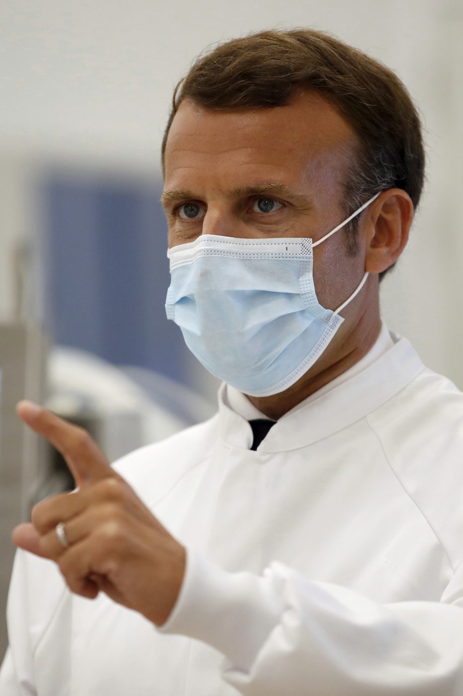 French President Emmanuel Macron visits an industrial development laboratory at the French drugmaker's vaccine unit Sanofi Pasteur plant in Marcy-l'Etoile, near Lyon, central France, Tuesday, June 16, 2020. The visit comes after rival pharmaceutical company AstraZeneca this weekend announced a deal to supply 400 million vaccine doses to EU countries, including France. (Gonzalo Fuentes/Pool via AP)