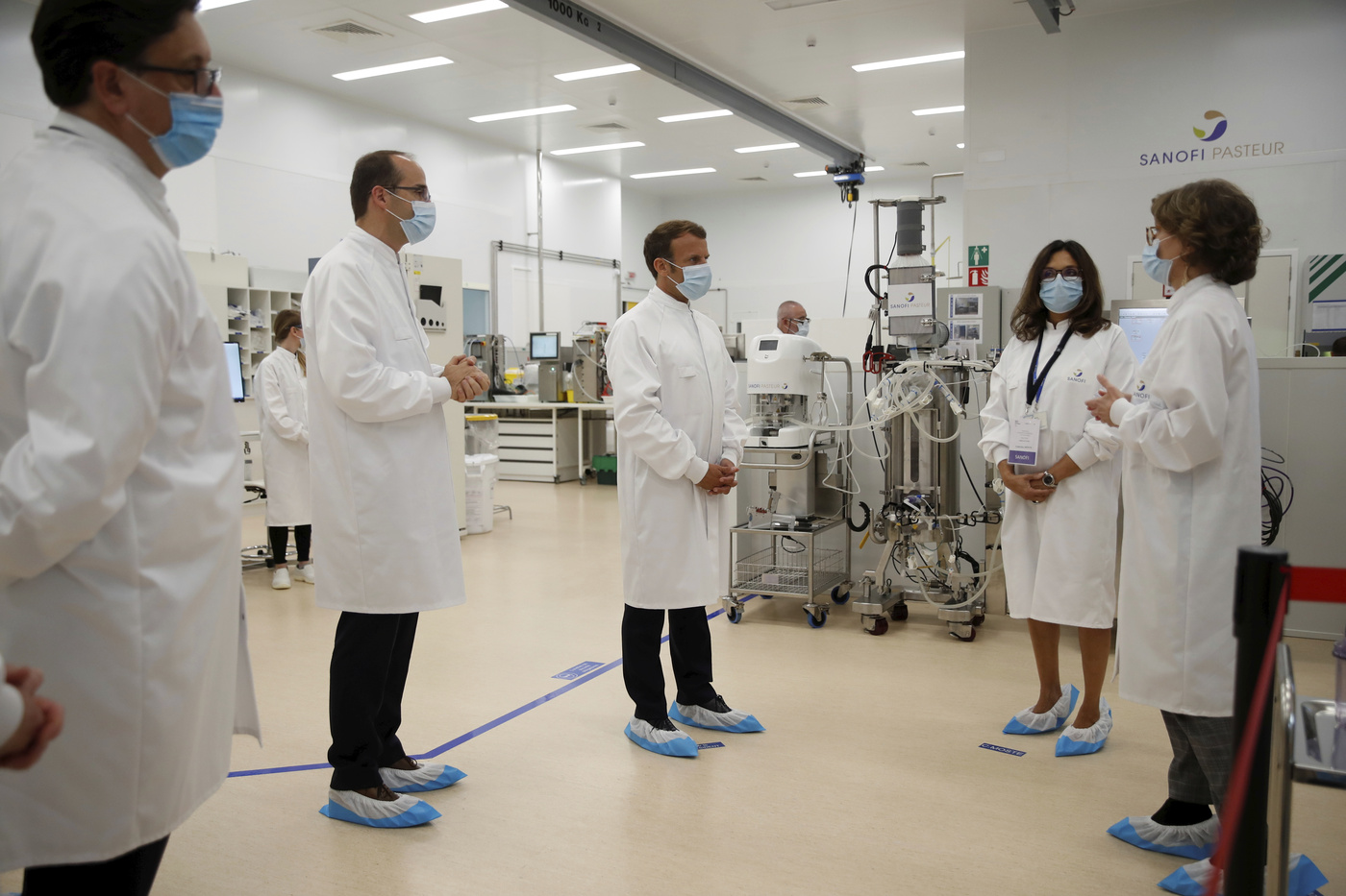 French President Emmanuel Macron visits an industrial development laboratory at the French drugmaker's vaccine unit Sanofi Pasteur plant in Marcy-l'Etoile, near Lyon, central France, Tuesday, June 16, 2020. The visit comes after rival pharmaceutical company AstraZeneca this weekend announced a deal to supply 400 million vaccine doses to EU countries, including France. (Gonzalo Fuentes/Pool via AP)