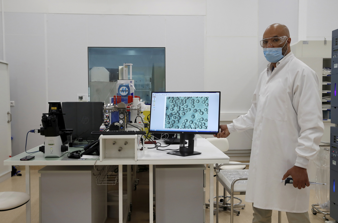 A researcher works at an industrial development laboratory at the French drugmaker's vaccine unit Sanofi Pasteur plant in Marcy-l'Etoile, near Lyon, central France, Tuesday, June 16, 2020. The visit comes after rival pharmaceutical company AstraZeneca this weekend announced a deal to supply 400 million vaccine doses to EU countries, including France. (Gonzalo Fuentes/Pool via AP)